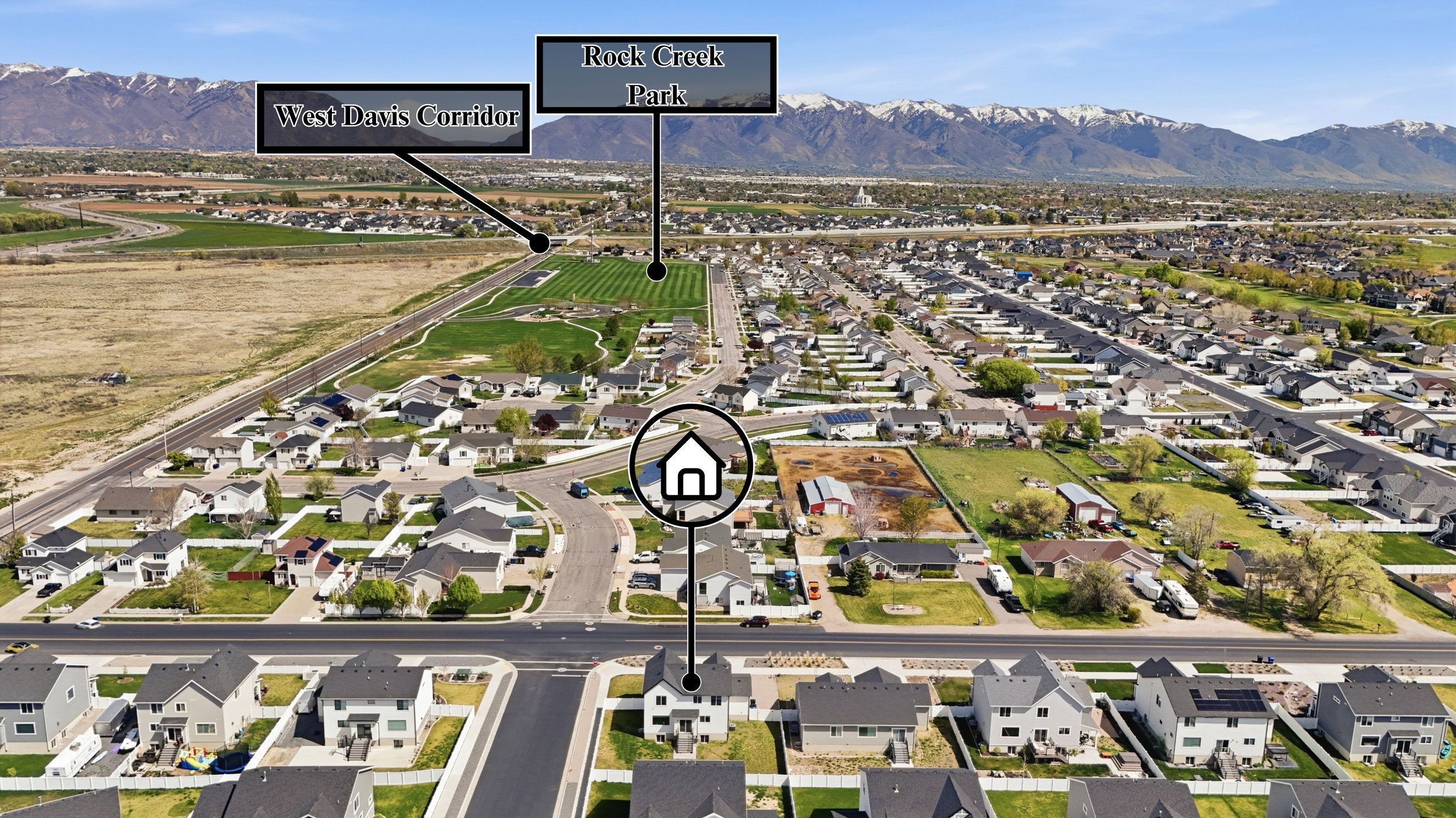 Aerial perspective showcasing a residential neighborhood with distant mountain ranges