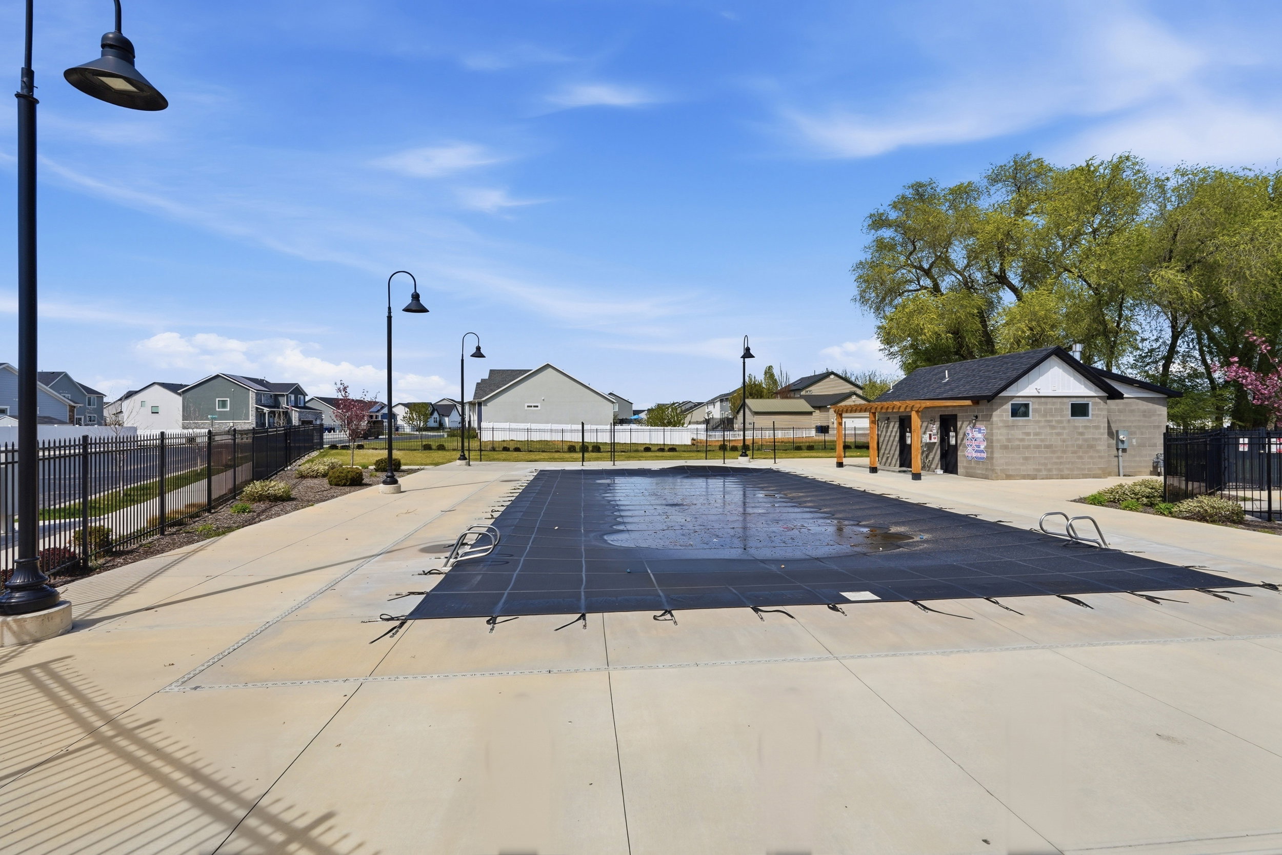 Expansive concrete pool deck surrounding a covered swimming pool