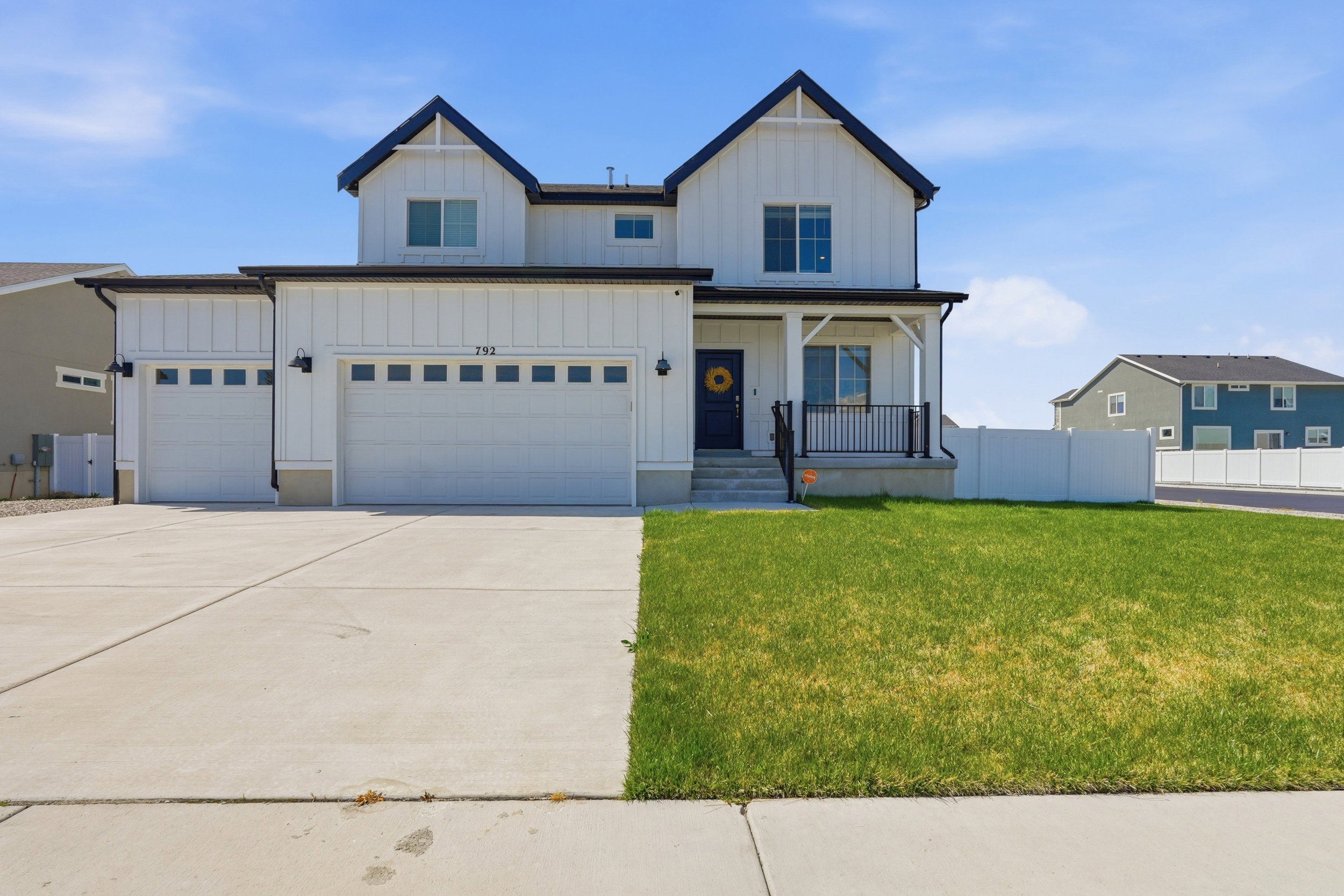 Modern Farmhouse exterior featuring vertical white siding and dark trim