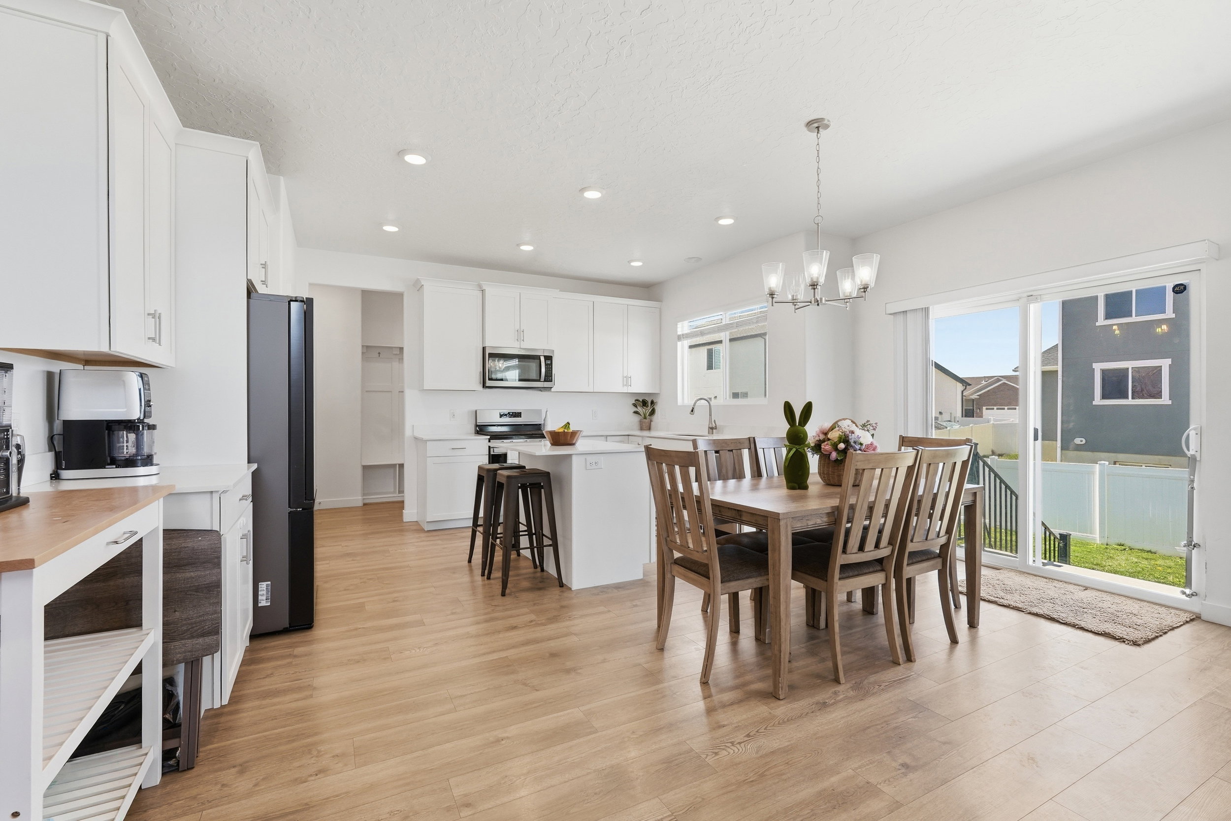 Open-concept kitchen and dining area featuring light wood-finish flooring