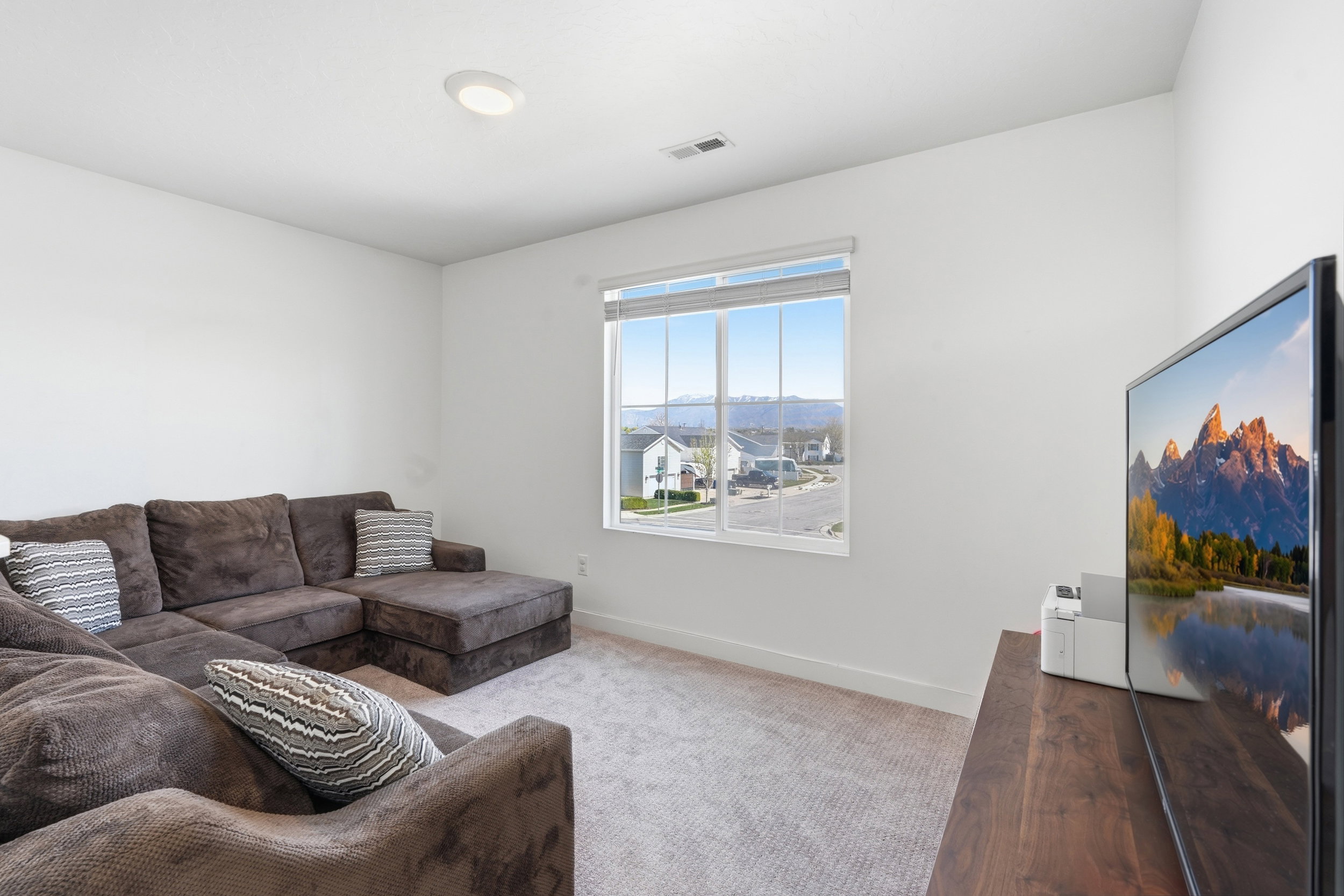 Carpeted room with a recessed ceiling light and a white window frame