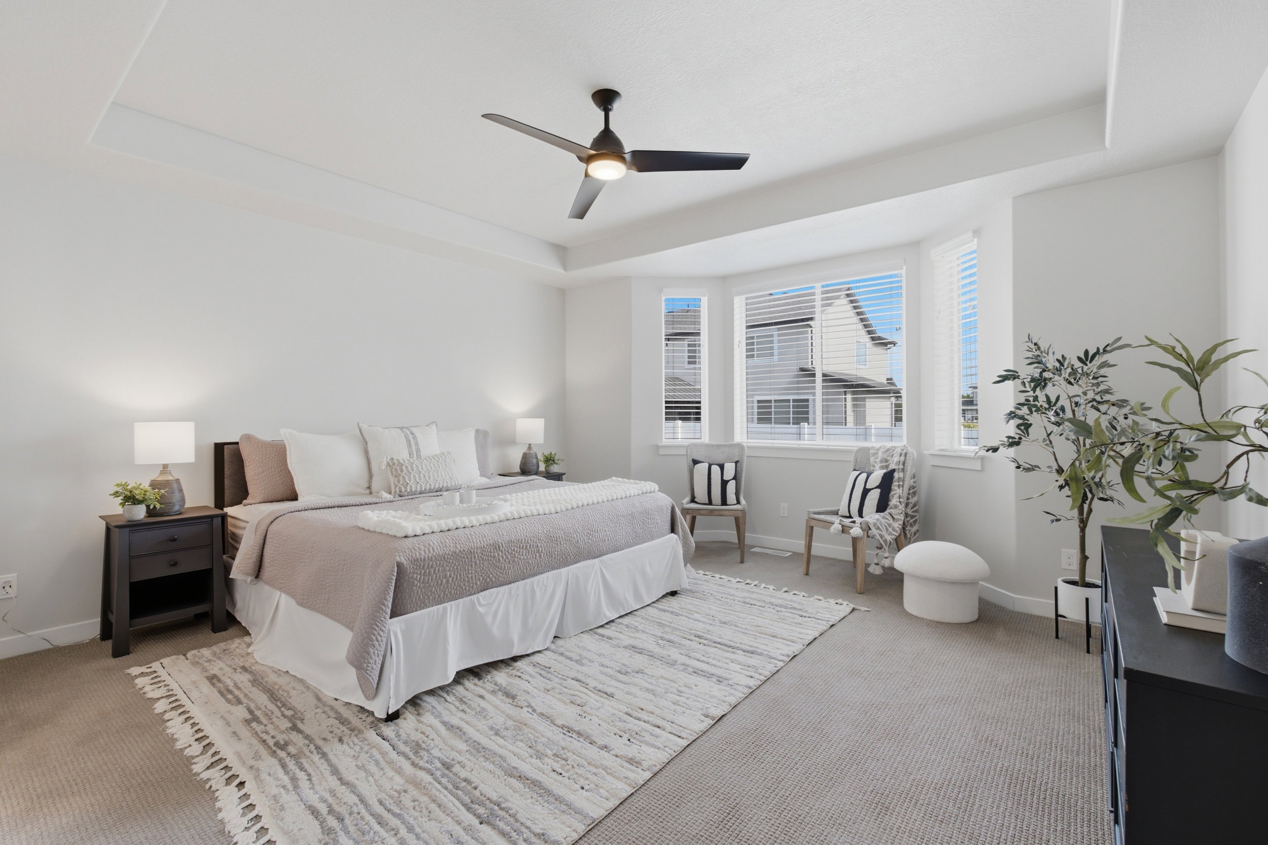 Spacious bedroom featuring a tray ceiling, recessed lighting, and a contemporary ceiling fan