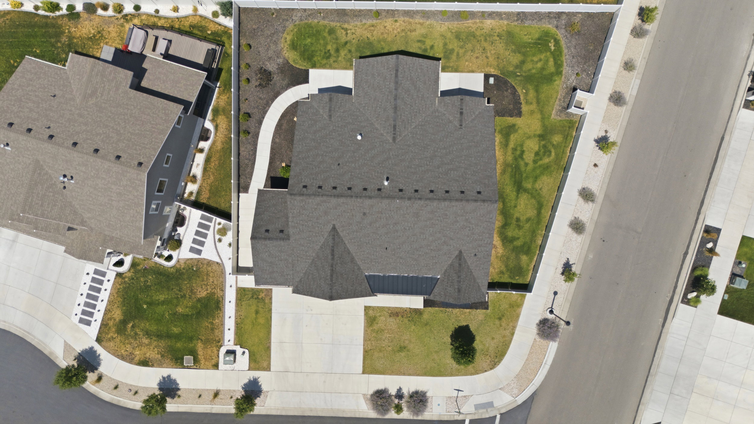 Gabled roofline residence featuring a concrete driveway and an established lawn