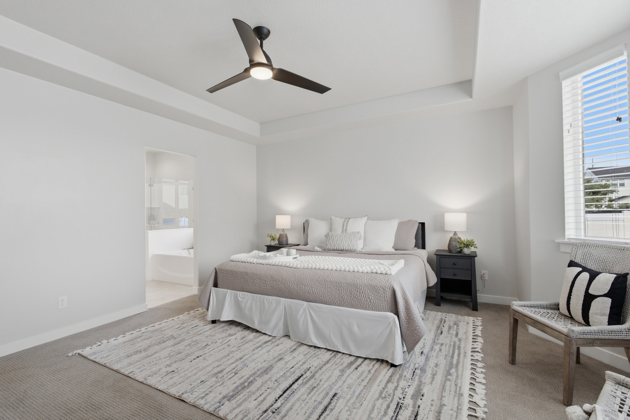 Bedroom with tray ceiling and contemporary ceiling fan