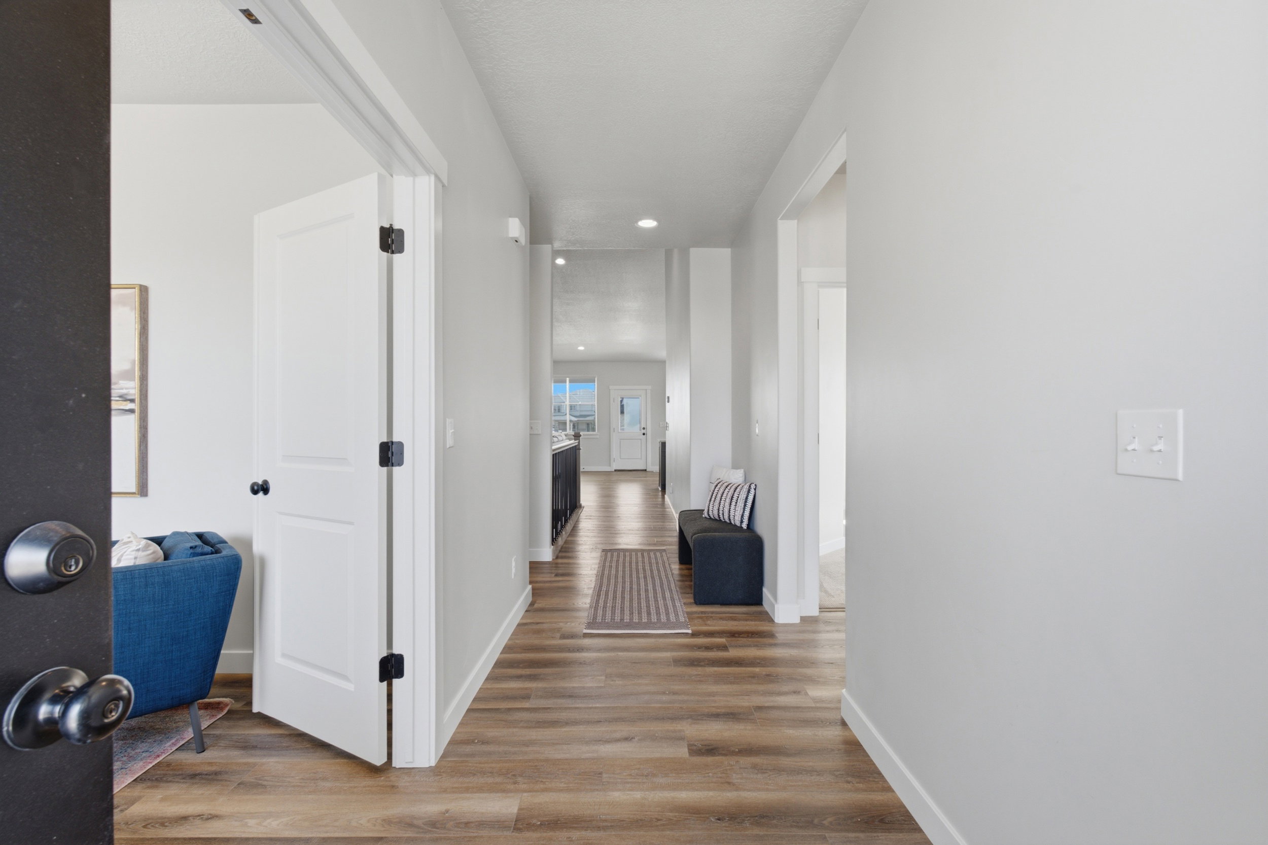 Entry hallway featuring wood-finish flooring and light gray walls