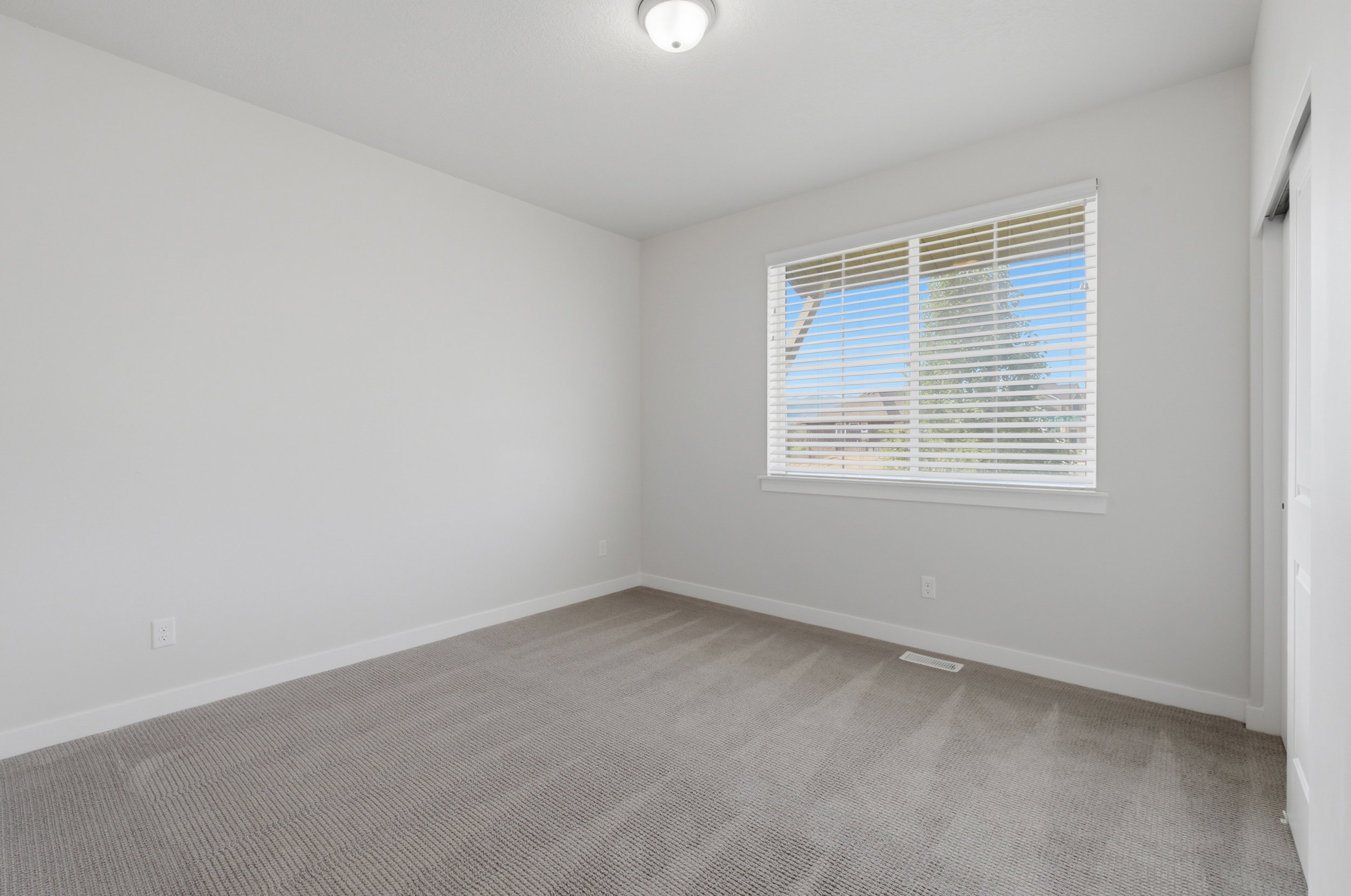 Neutral wall paint complementing textured gray carpeting