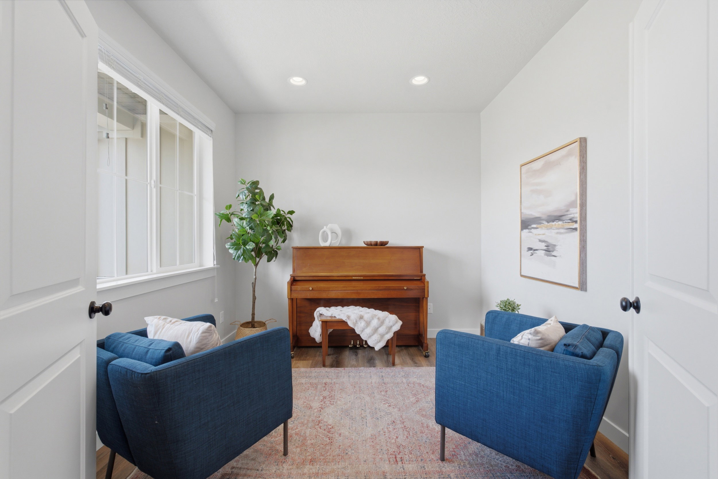Room featuring a large multi-pane window, recessed lighting, and wood-finish flooring