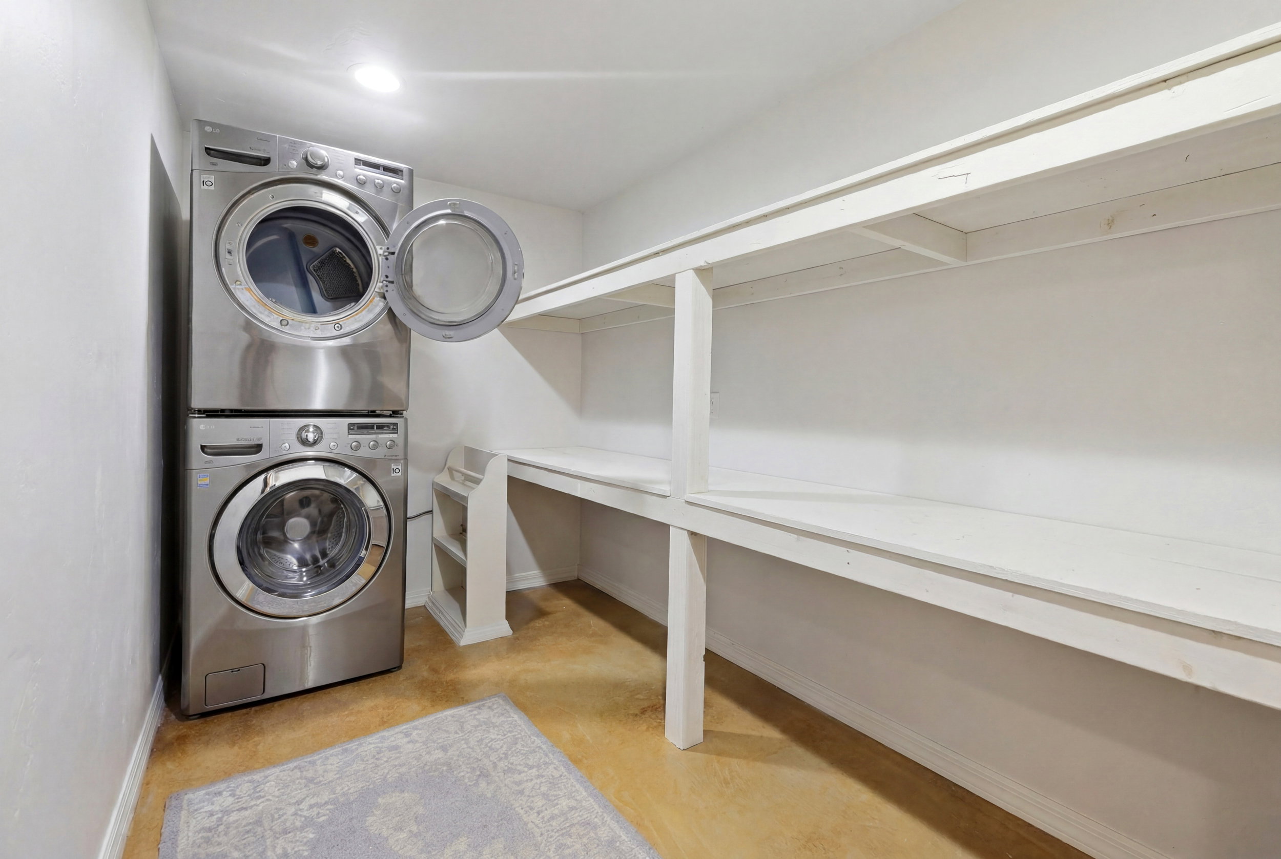 Dedicated laundry area featuring a stacked washer and dryer unit