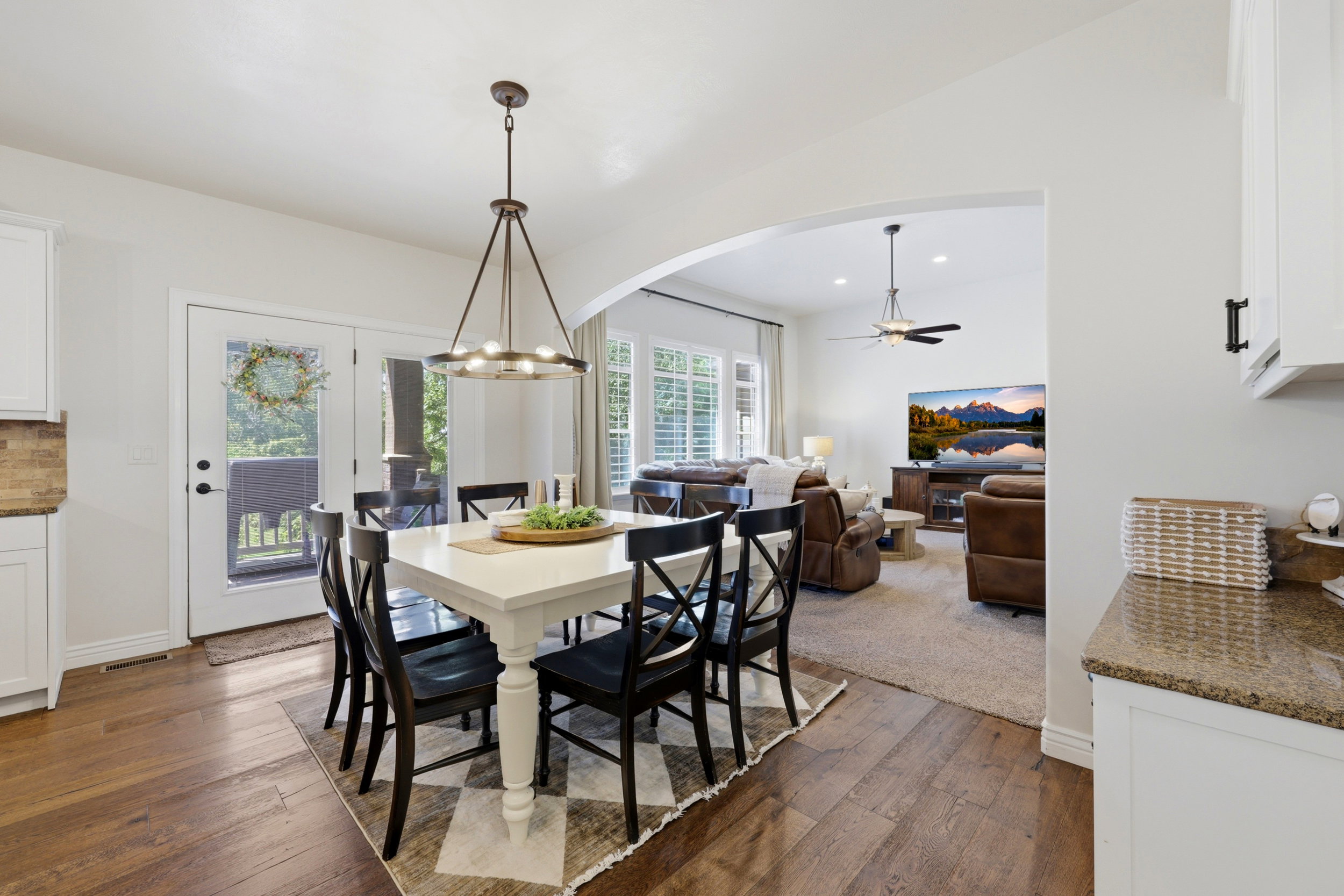Dining area featuring wood-finish flooring and a contemporary chandelier