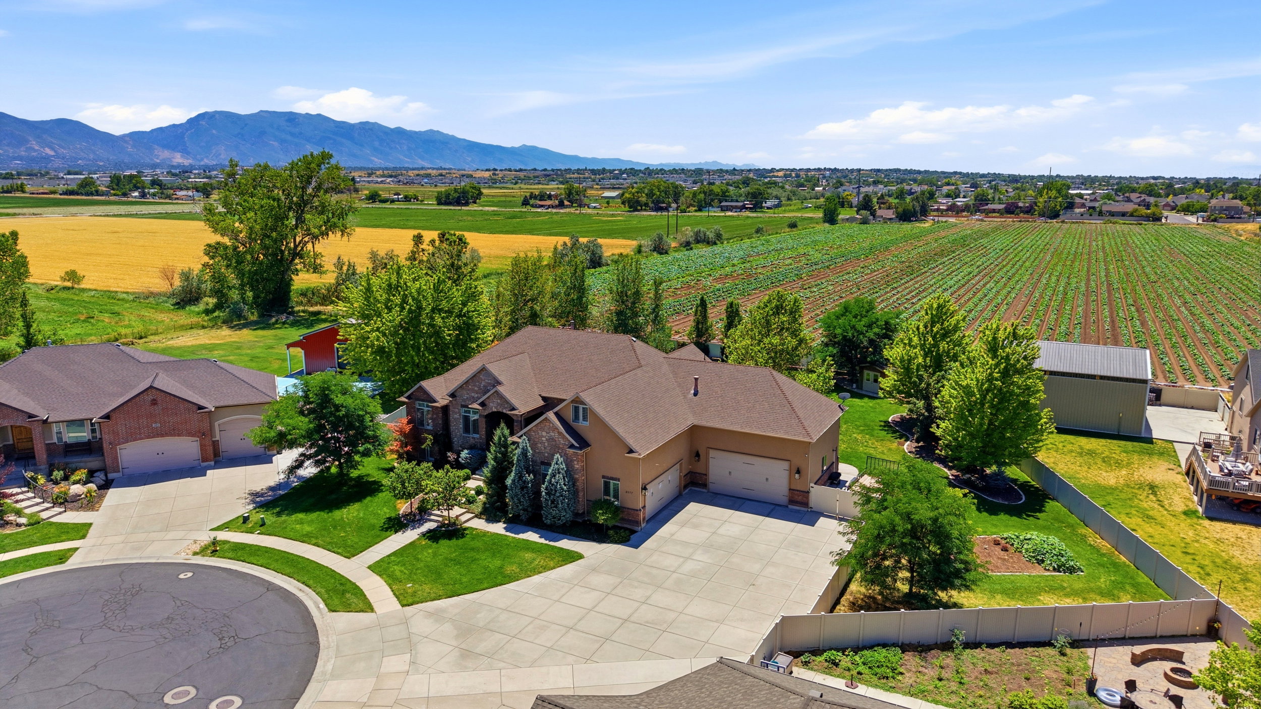 Expansive suburban property featuring a large residence with an attached three-car garage