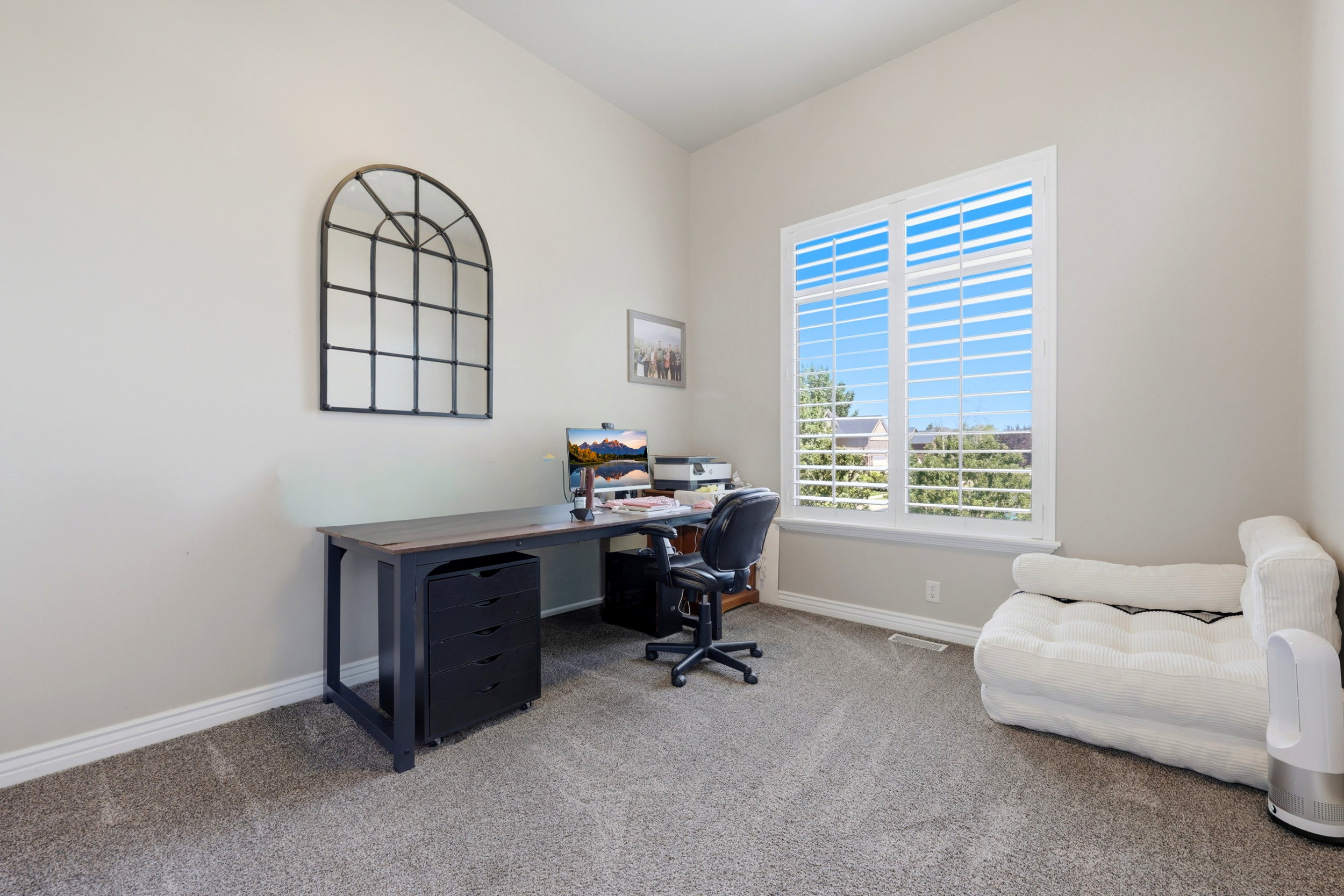 Spacious room with high ceilings, light gray wall paint, and gray carpet flooring