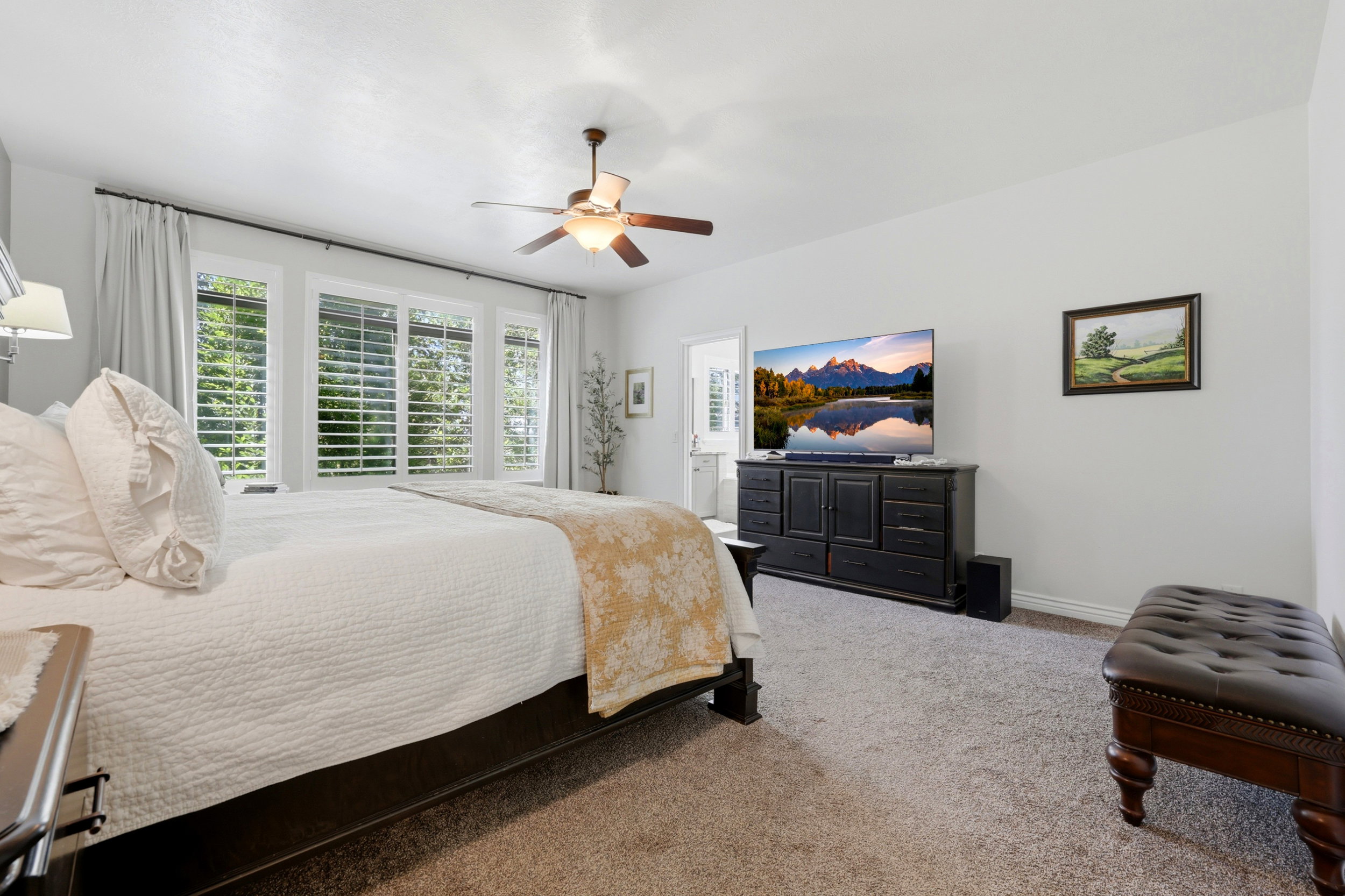 Spacious bedroom with light-toned walls and carpet flooring
