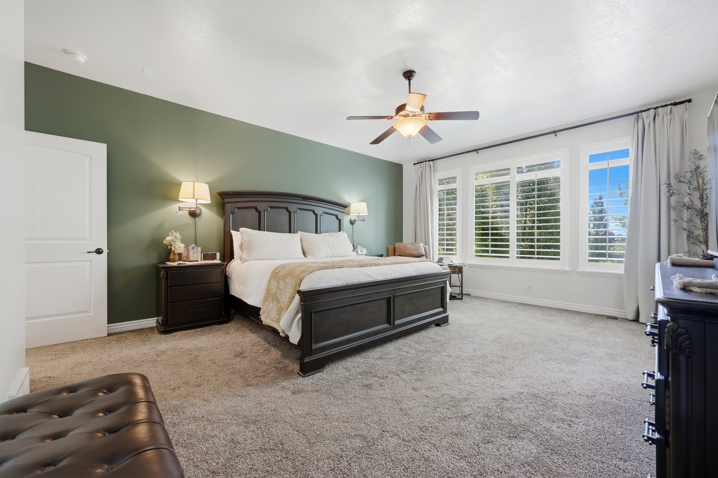 Spacious room with plush carpeting, a feature wall, and white trim