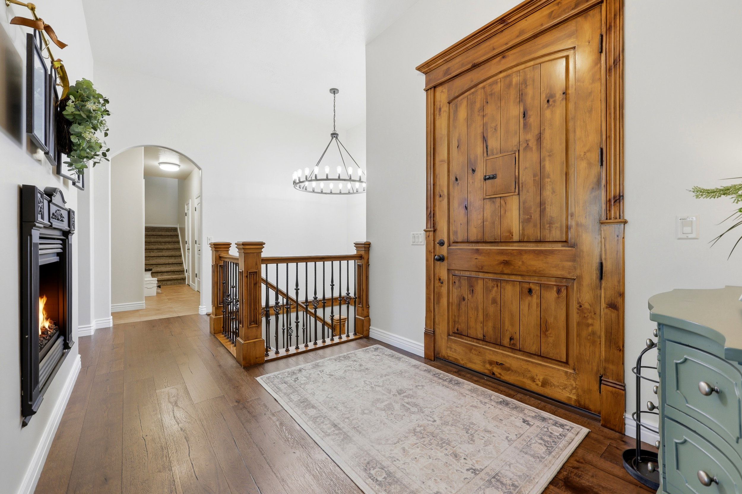 Grand entryway featuring a substantial wood door with decorative molding