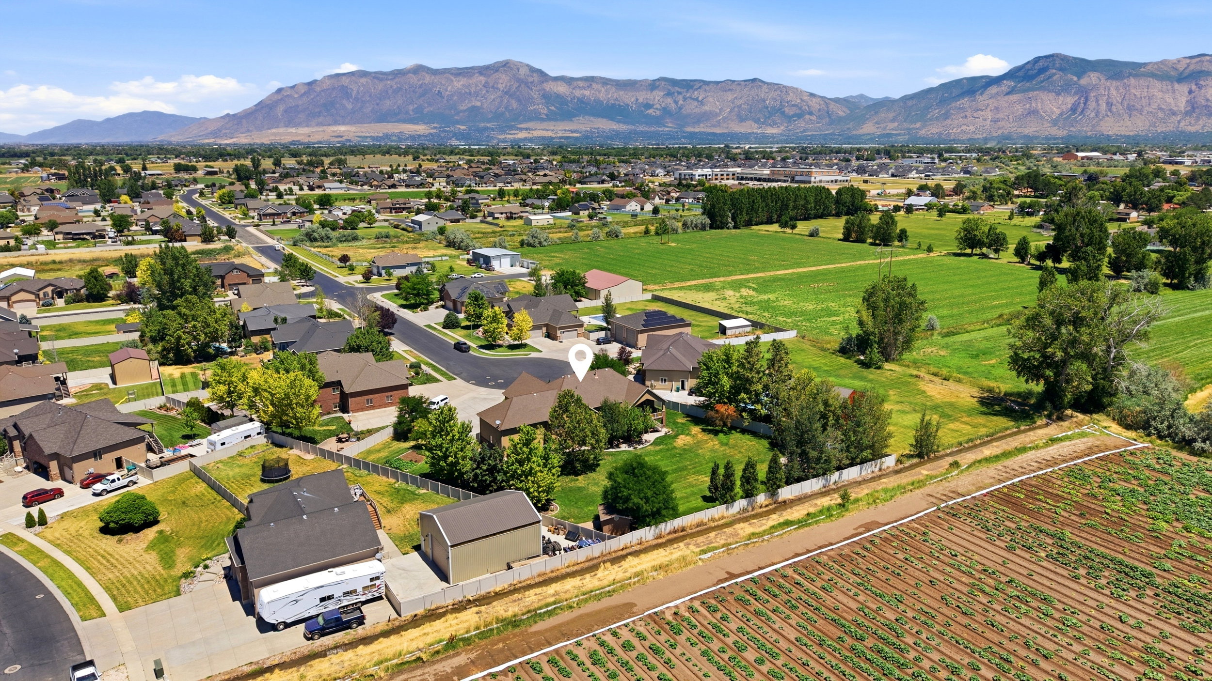 Expansive residential area featuring established homes, mature trees, and mountainous terrain