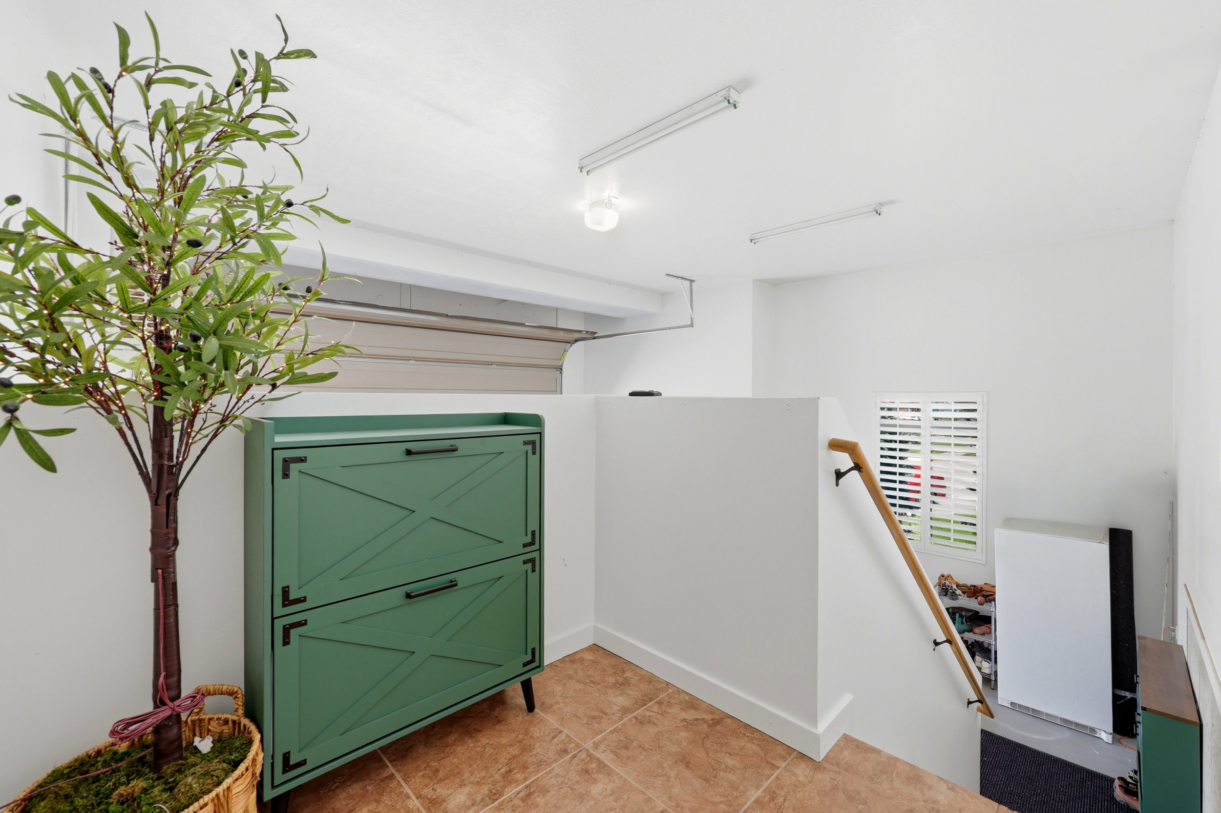 Entryway with terracotta-style tile flooring and crisp white walls