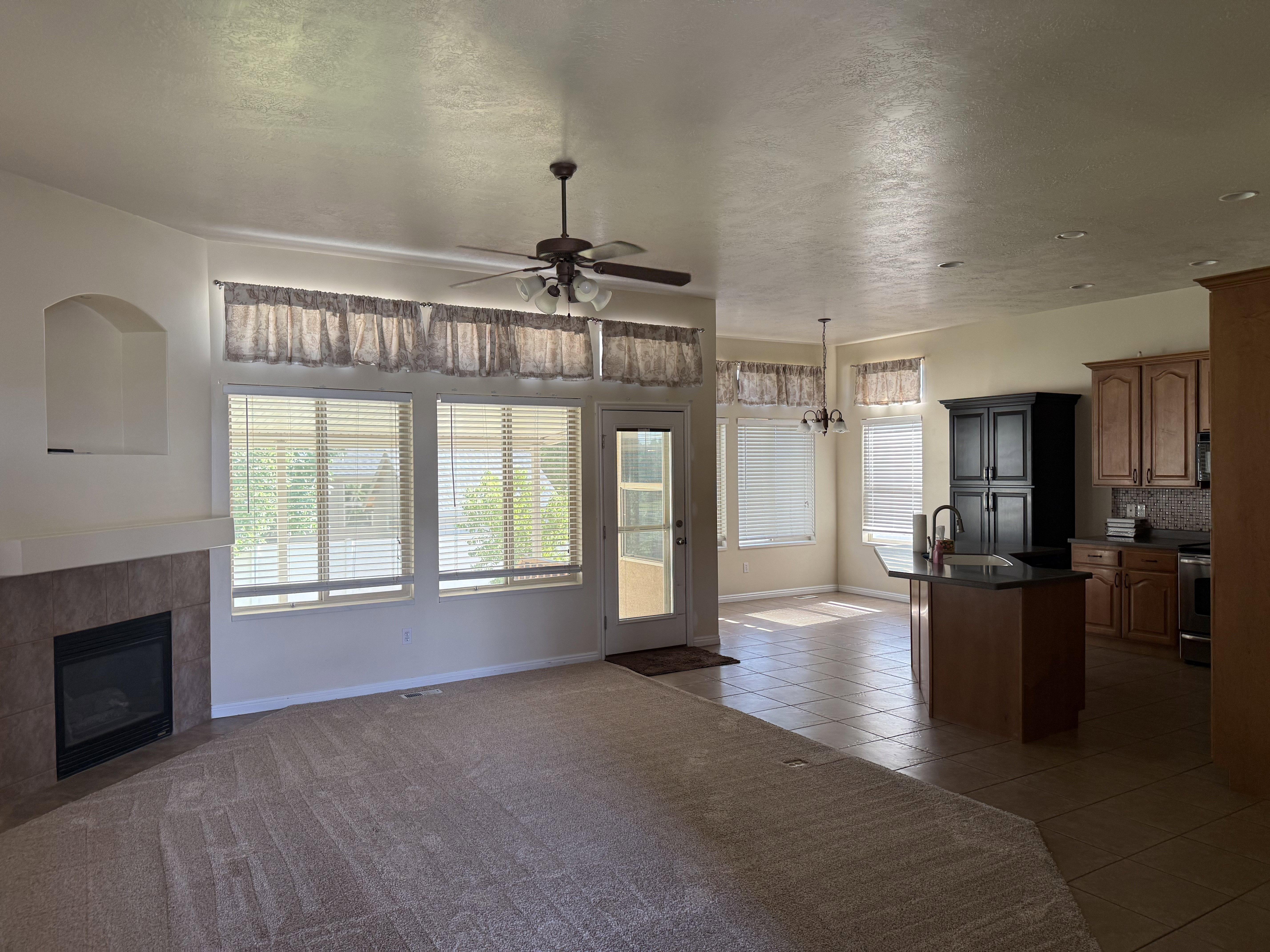 Spacious living area featuring a tiled fireplace and a built-in display niche