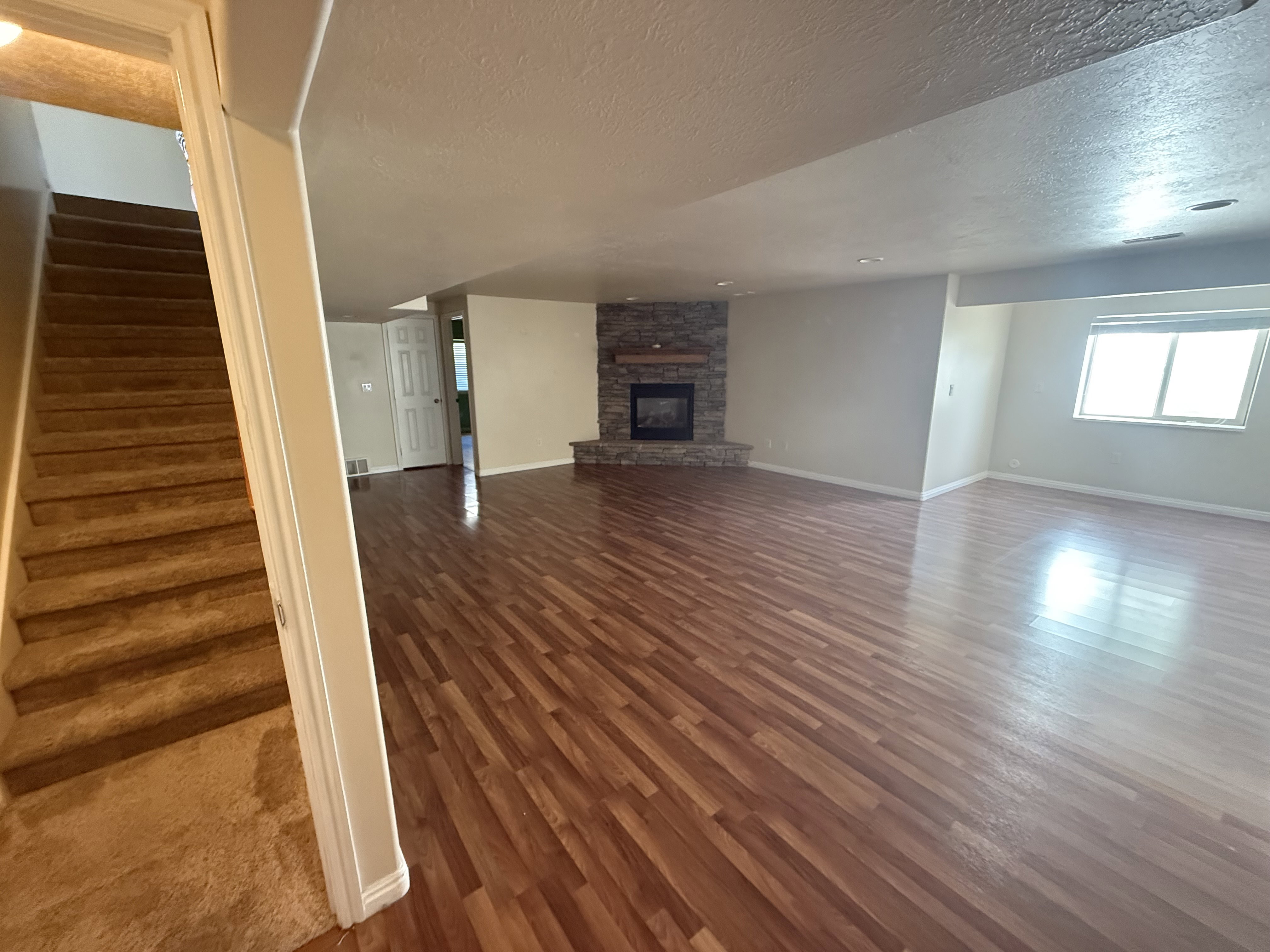 Spacious lower-level area featuring wood-finish flooring