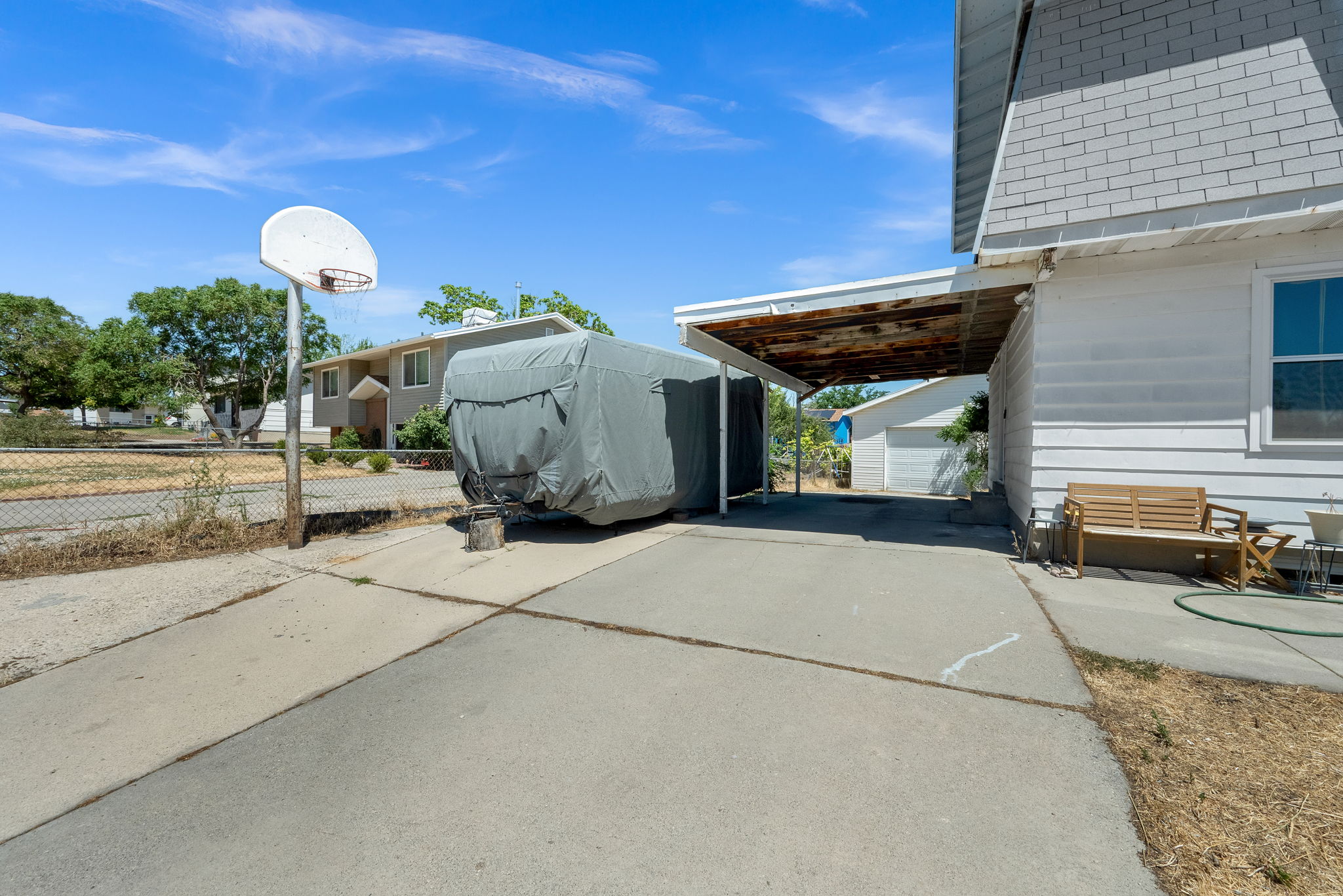 Concrete driveway with a covered carport