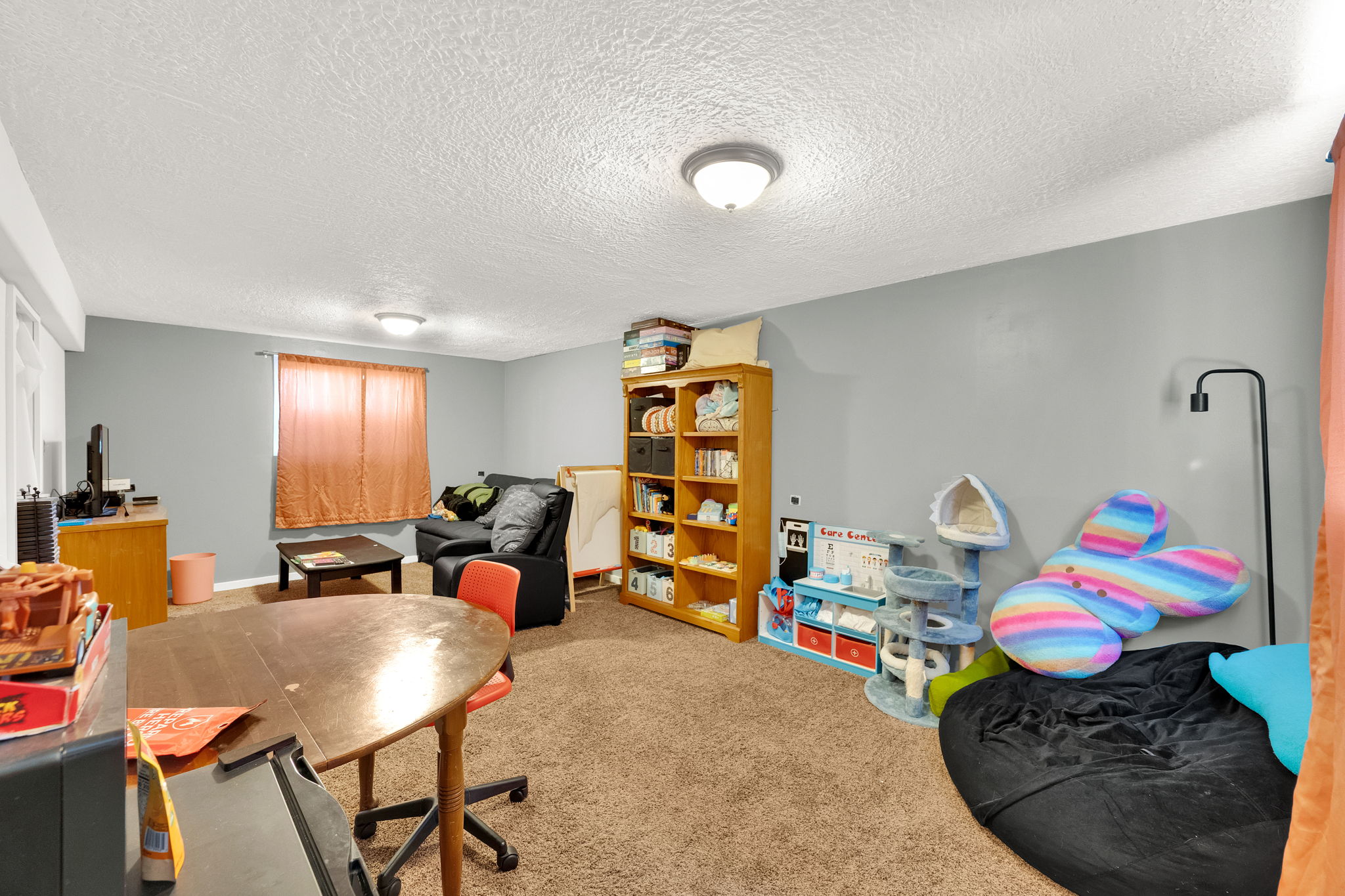 Carpeted room with light grey walls and white ceilings