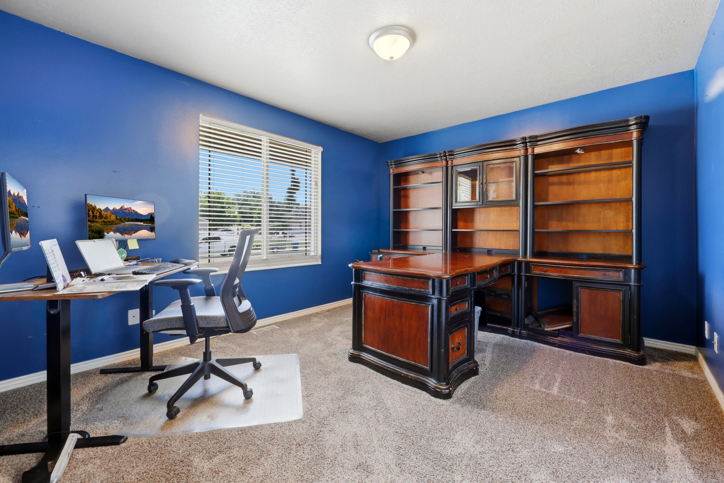 Wood and black-finish desk and shelving unit, featuring glass-front cabinetry and ample storage space