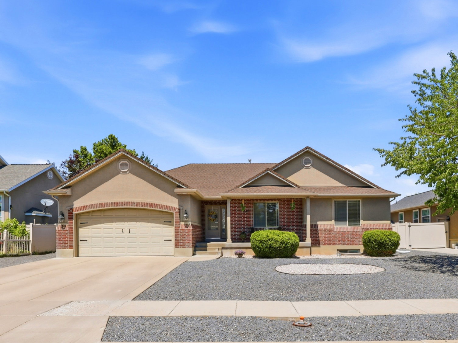 Single-story stucco exterior with brick accents