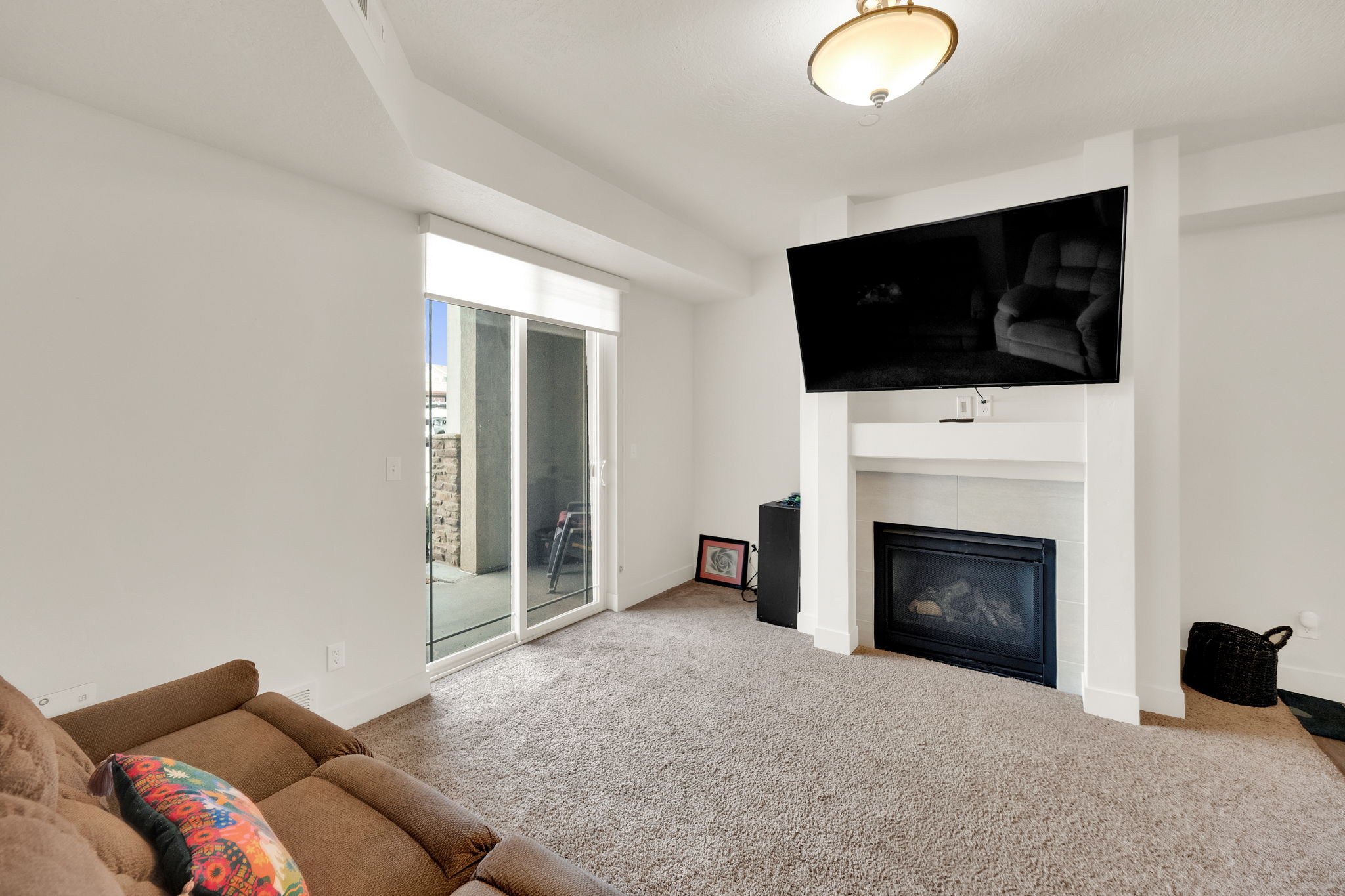 Living area featuring neutral-toned carpeting and white walls