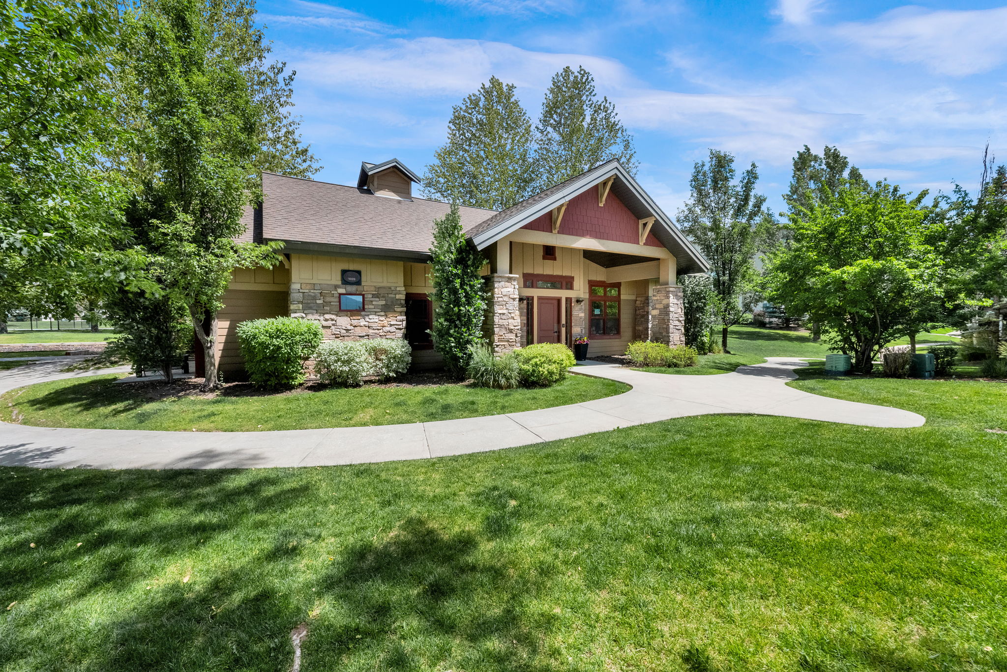Craftsman-style exterior with stone and siding accents, featuring a prominent gabled entryway
