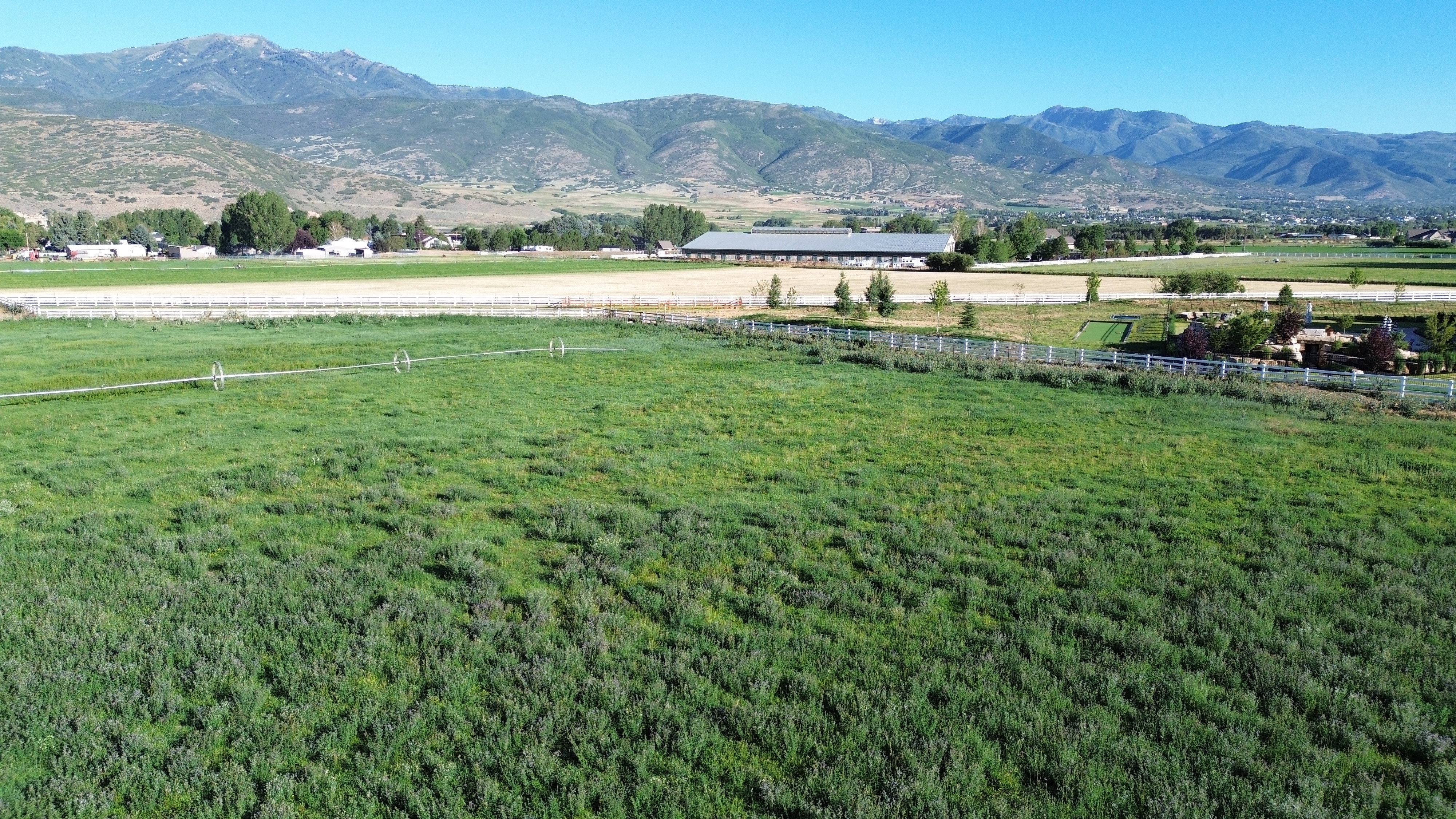 Expansive green fields featuring irrigation systems