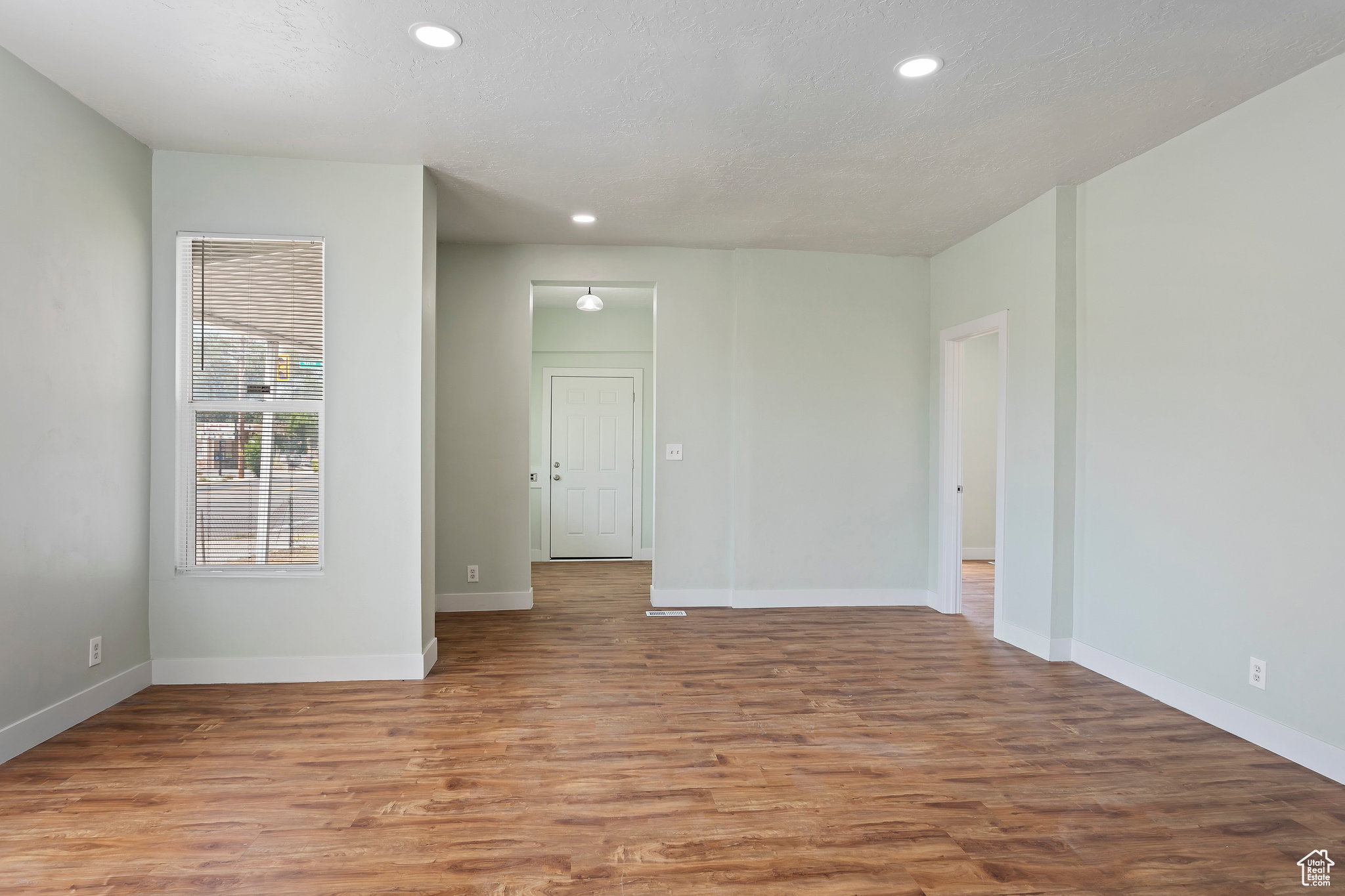 Spacious interior featuring wood-finish flooring, recessed lighting, and a neutral wall palette