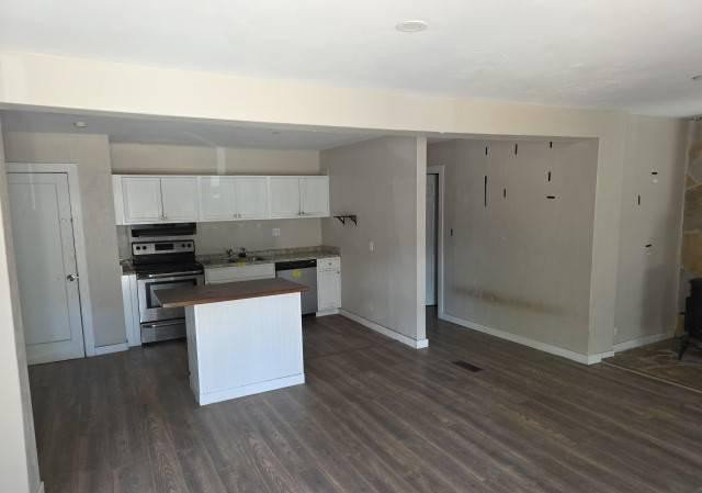 Open-concept living space featuring wood-finish flooring throughout