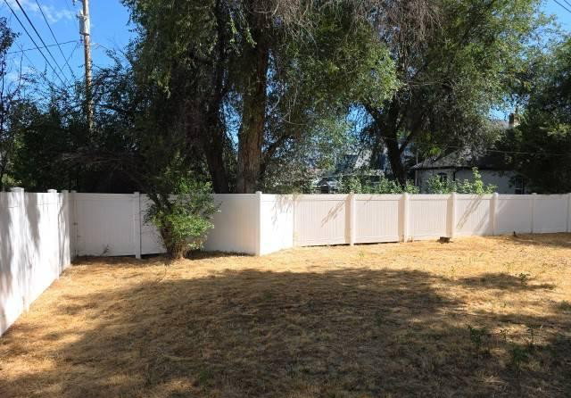 Private backyard with a full perimeter fence and established trees