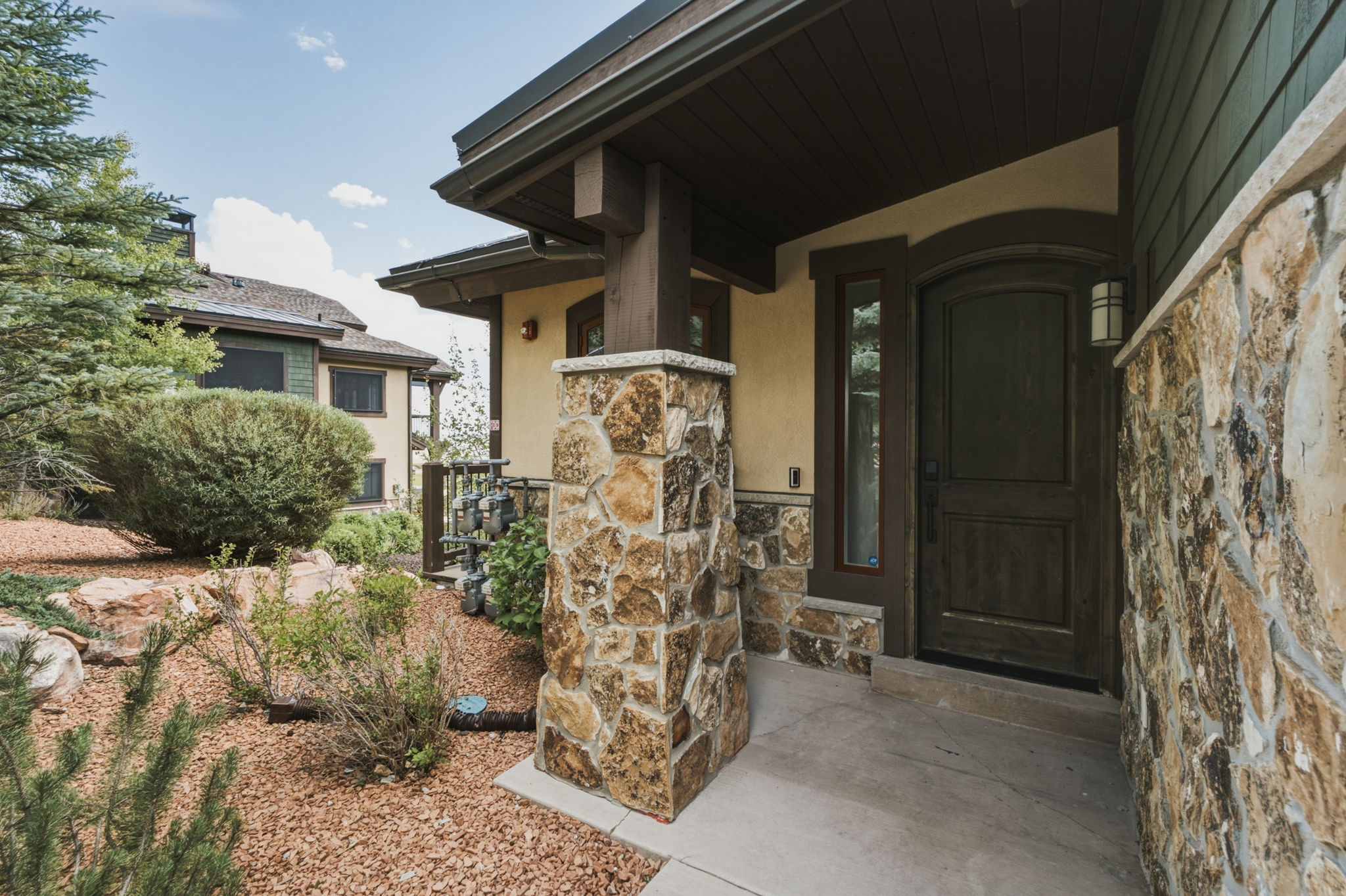 Front Door - stone veneer exterior with a prominent arched entry door