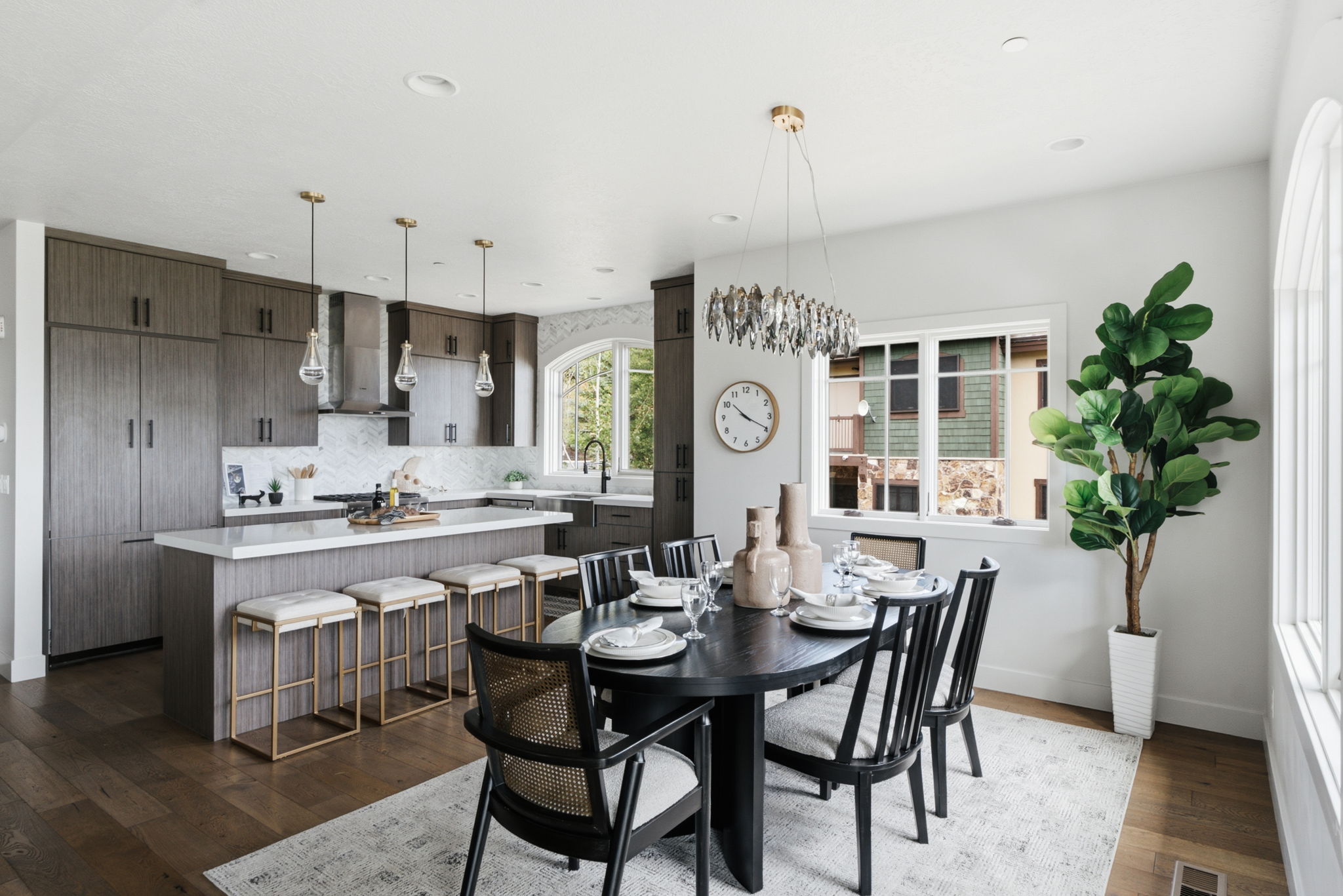 Open-concept kitchen and dining area featuring wood-finish flooring