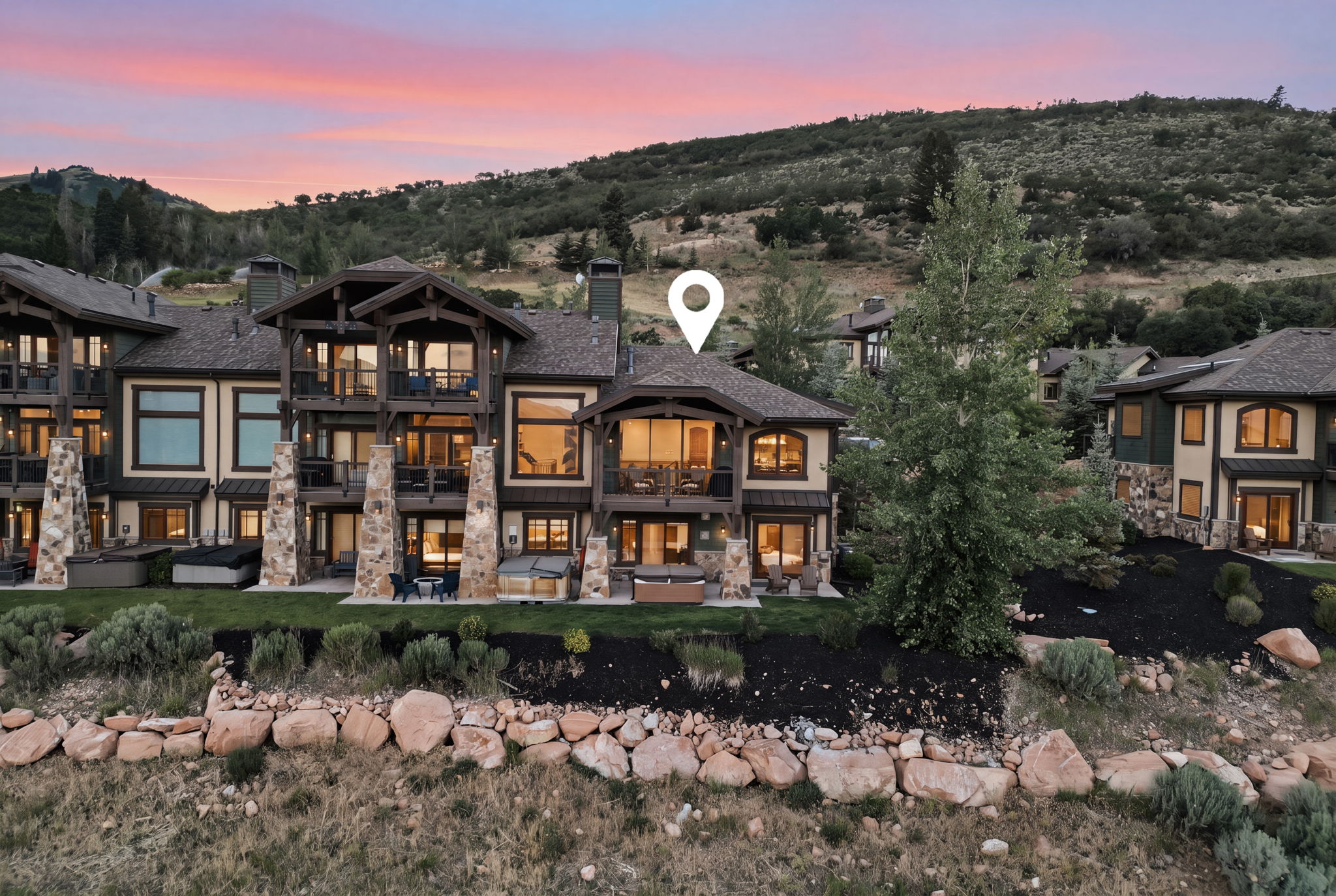 Multi-level residence featuring extensive natural stone and wood beam accents