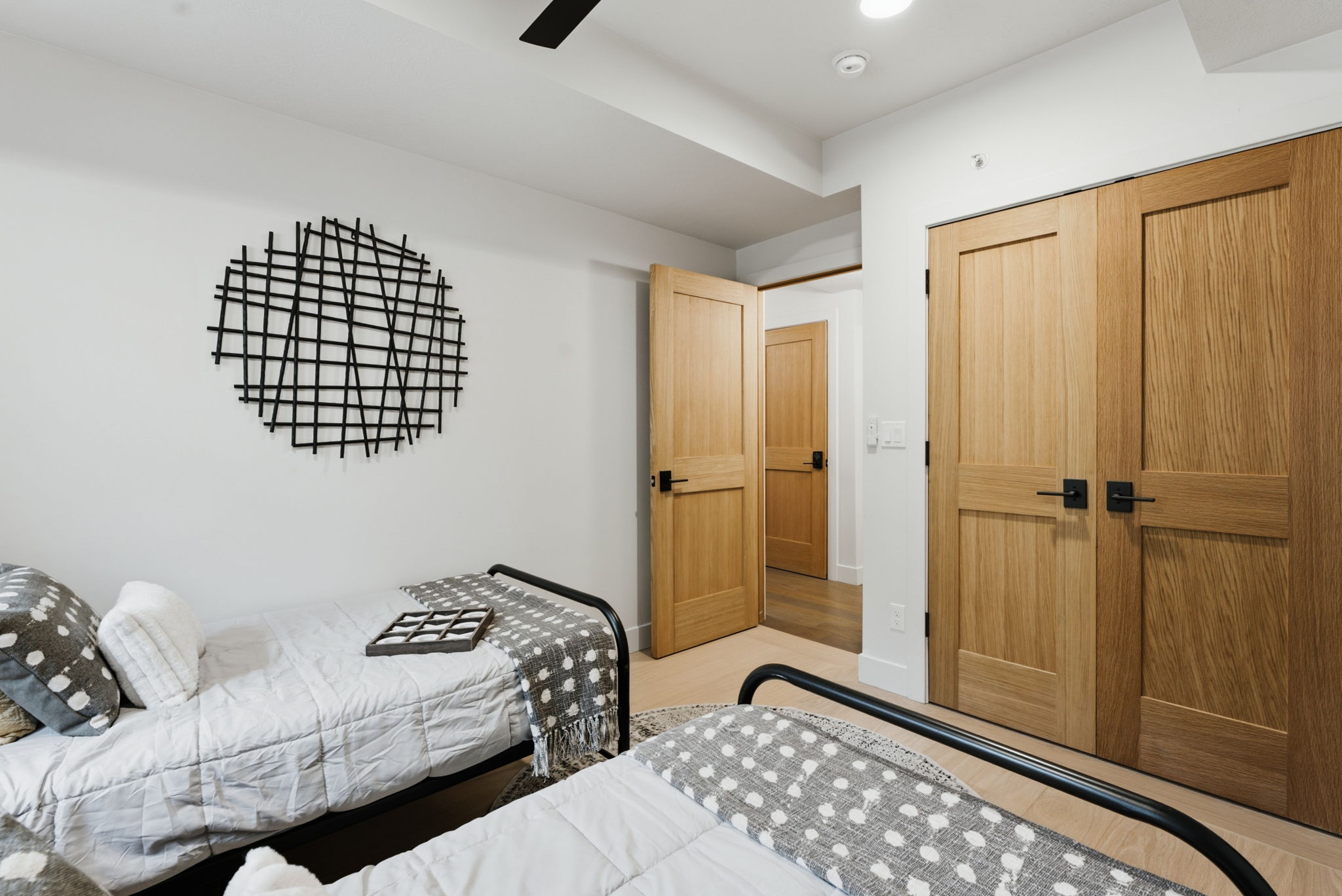 3rd Bedroom with light wood-finish doors featuring matte black hardware, white walls, and recessed lighting