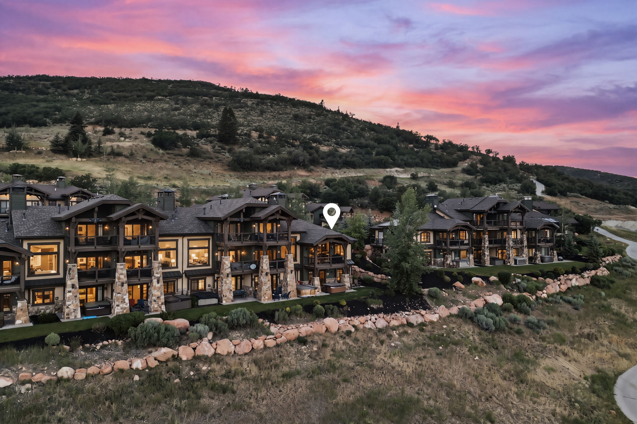 Terraced multi-story residences featuring extensive stone and timber architectural elements