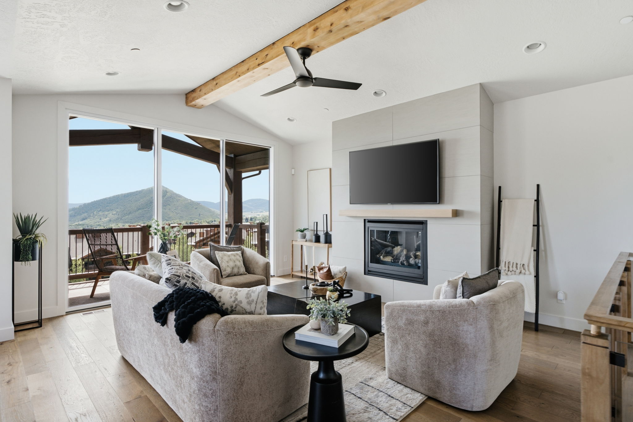 Vaulted living area featuring a wood beam ceiling, recessed lighting, and a contemporary ceiling fan