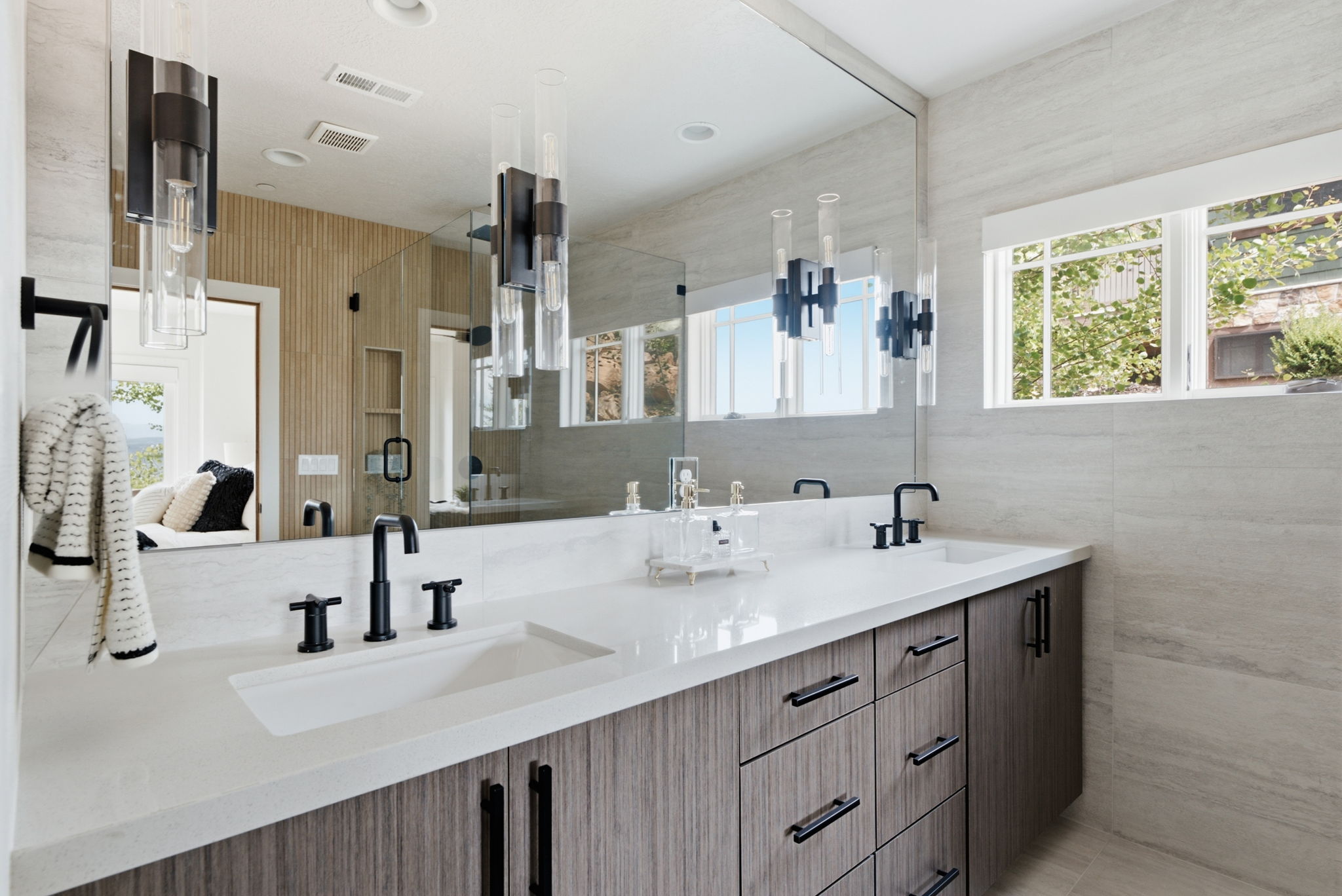 Dual vanity with integrated white rectangular sinks, white countertop, and matte black fixtures