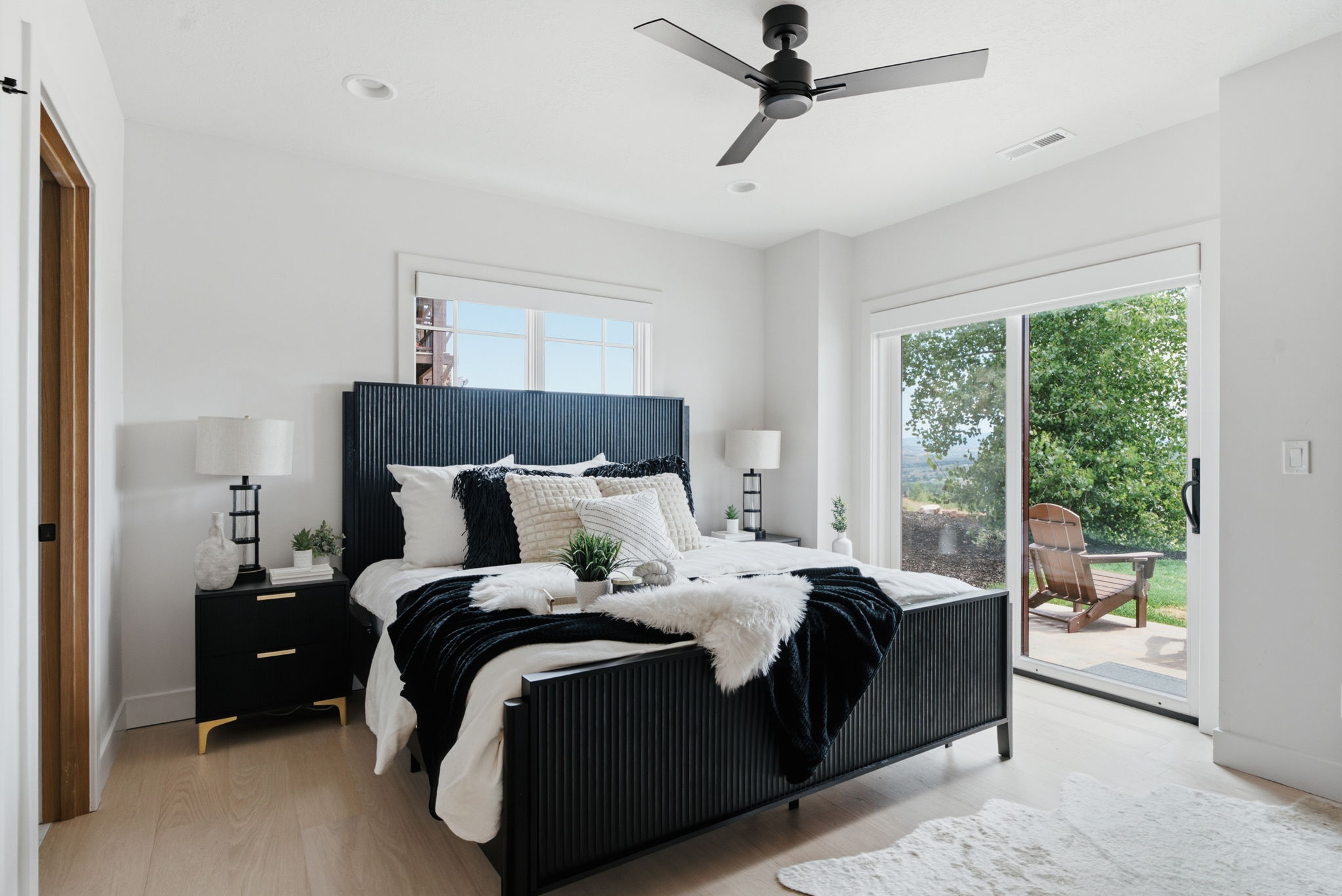 Primary suite featuring new wood flooring, contemporary ceiling fan, recessed lighting, patio & hot tub access