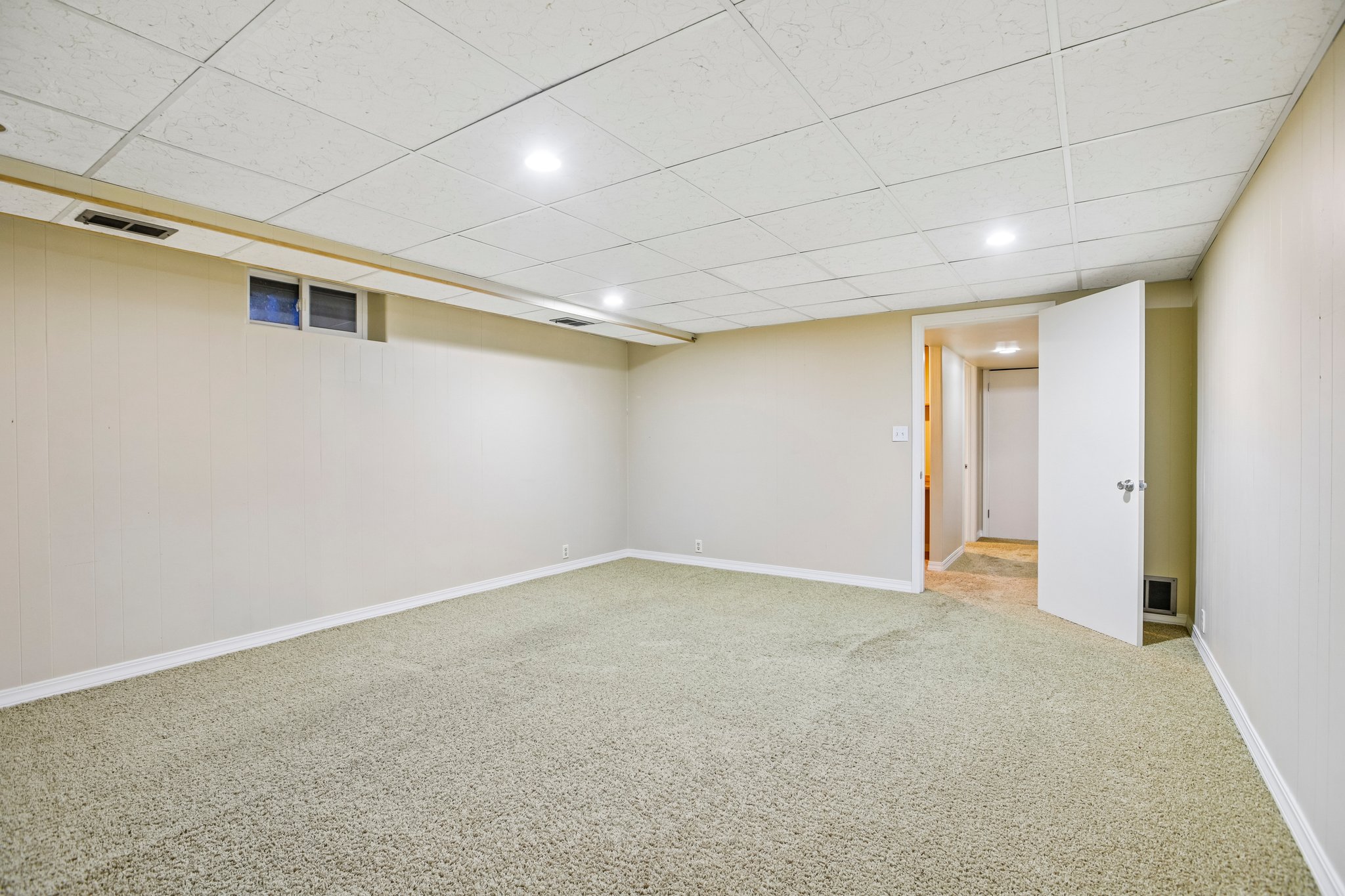 Carpeted room with recessed lighting and a drop ceiling