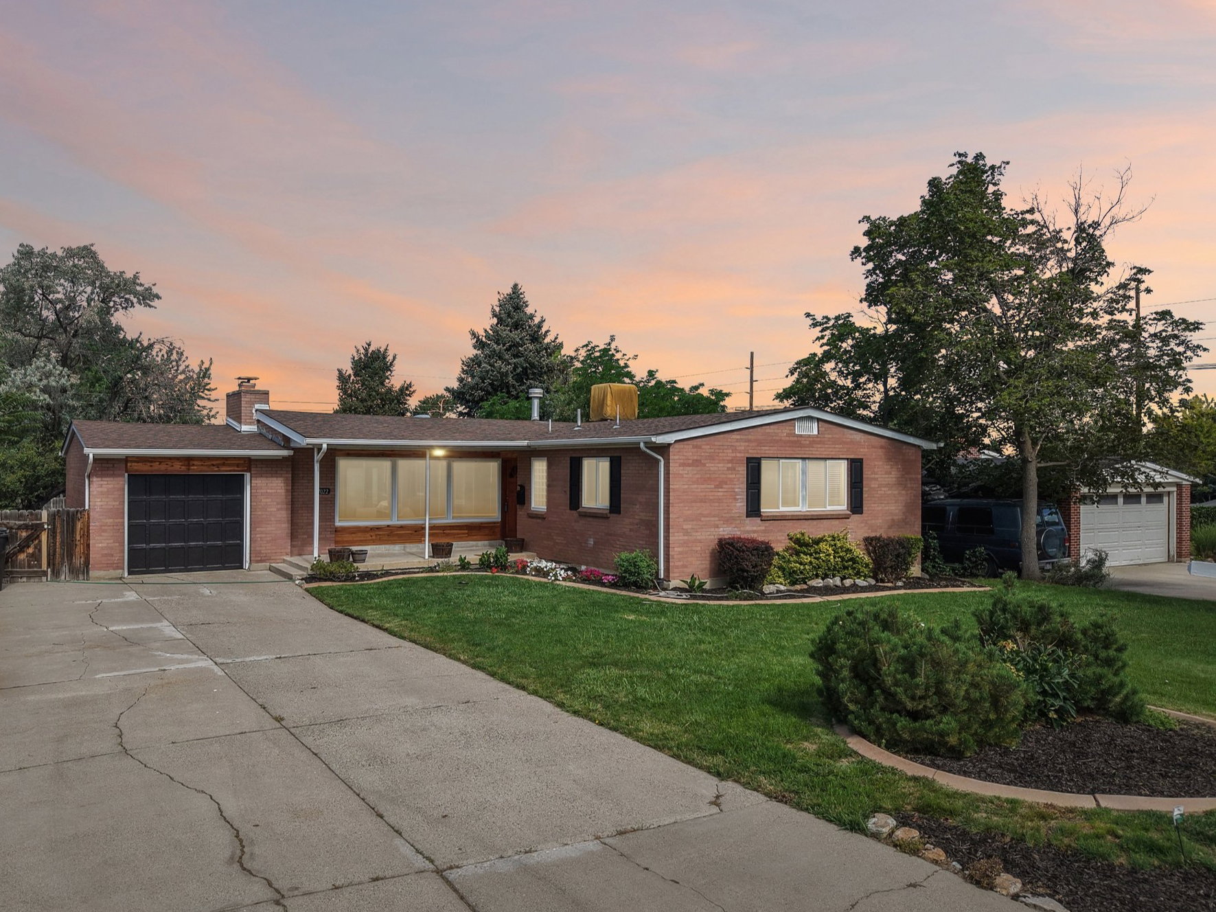 Brick exterior with a single-car garage and a paved driveway