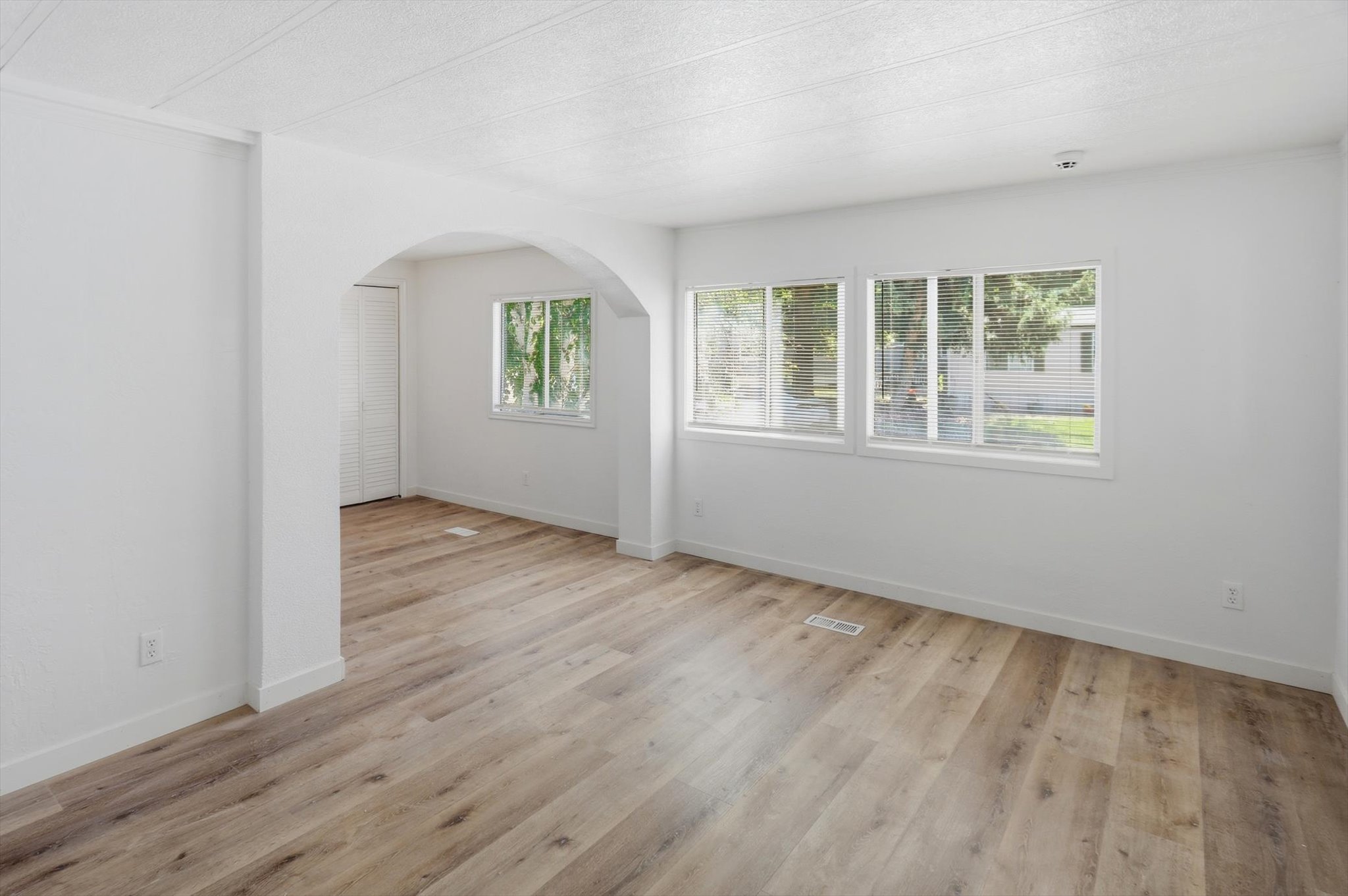 Light wood-finish flooring throughout the room