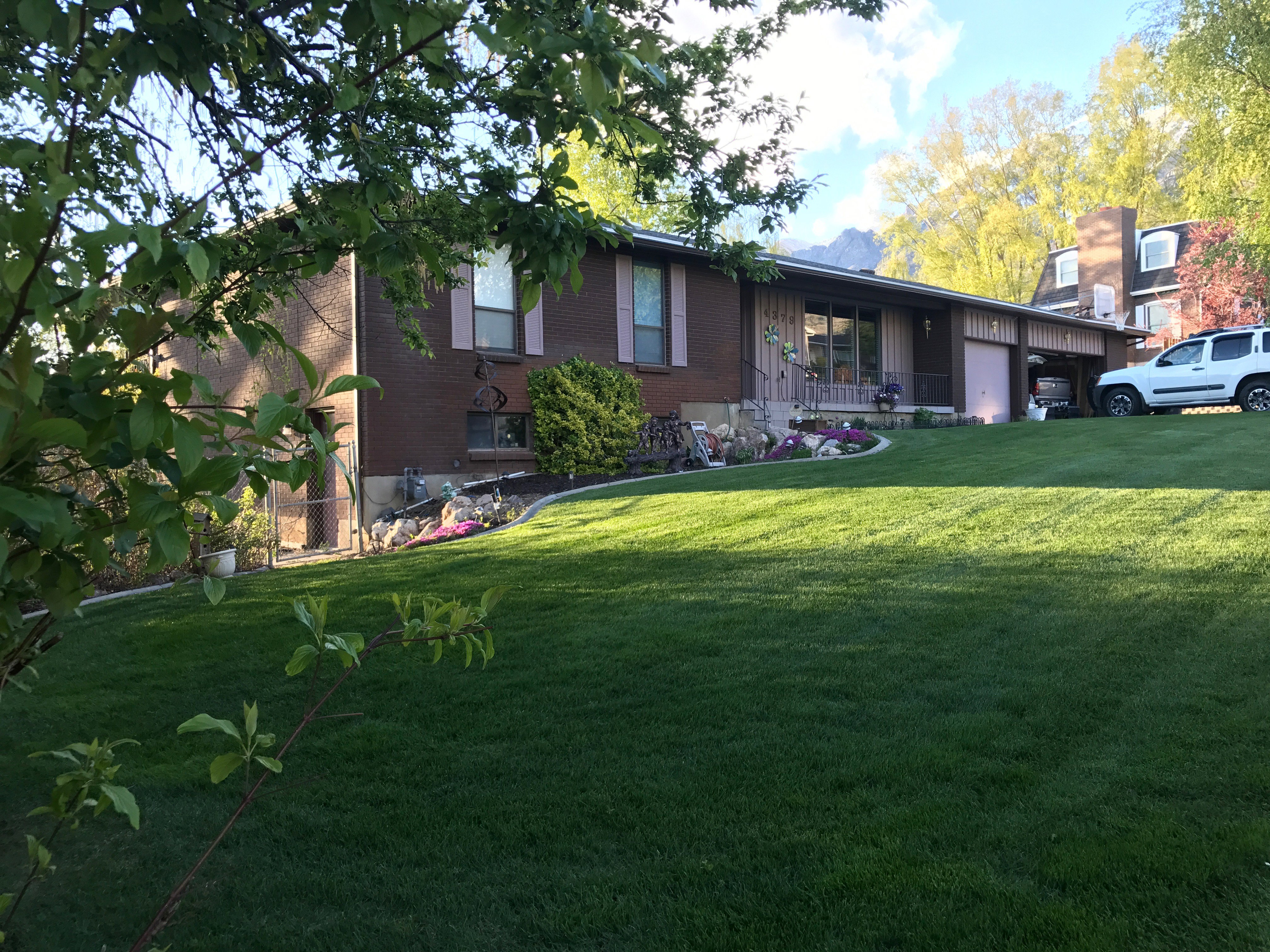 Split-level residence featuring a brick and wood-paneled exterior