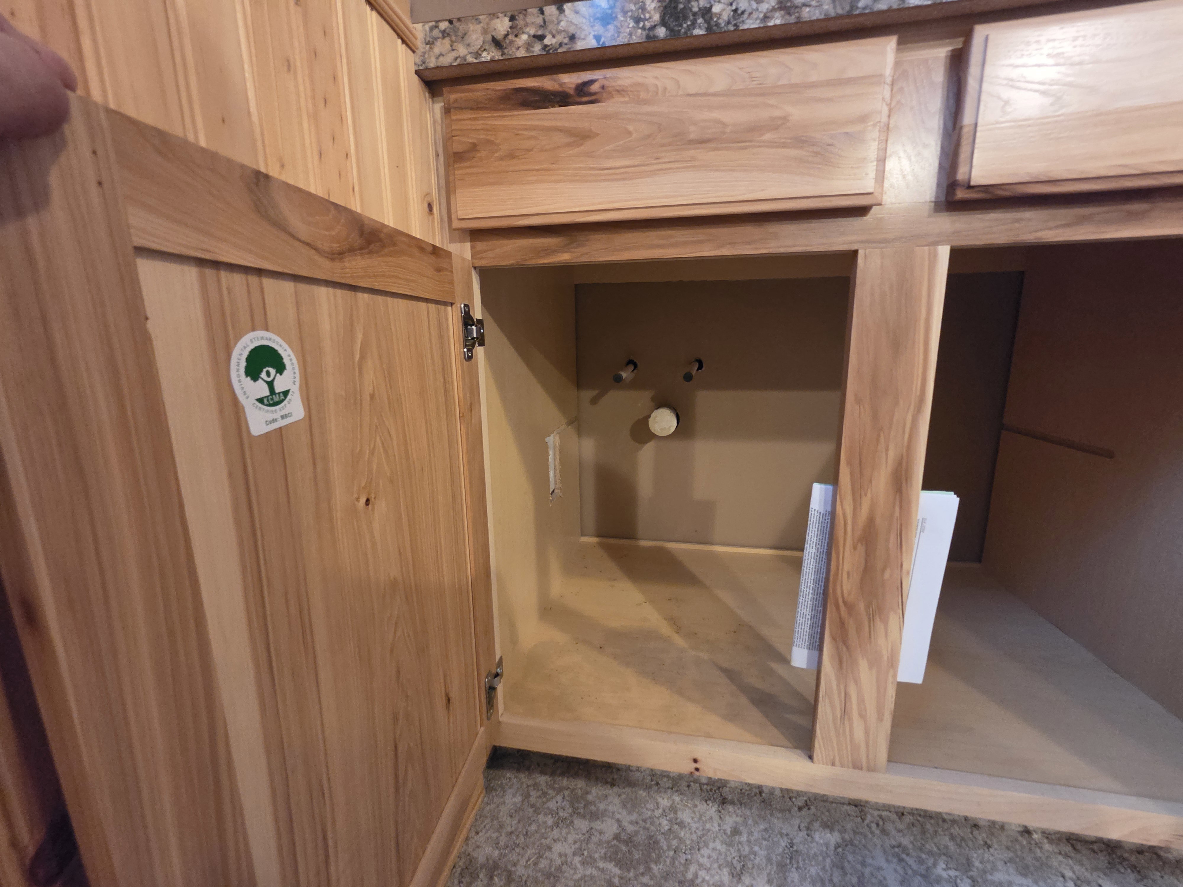 Natural wood-finish cabinetry with recessed panel doors and drawer fronts
