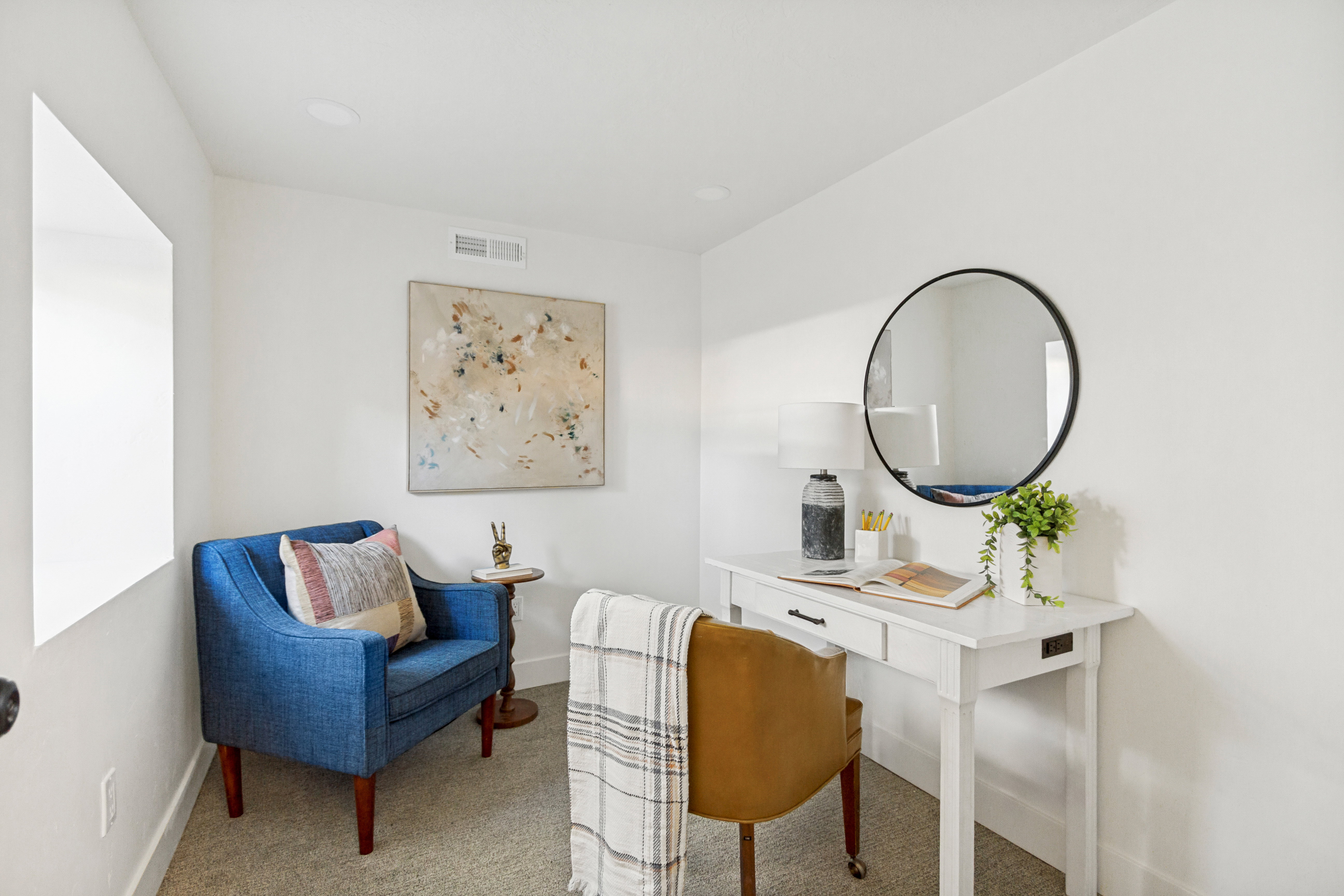 Neutral wall finishes and recessed lighting complement the carpeted flooring