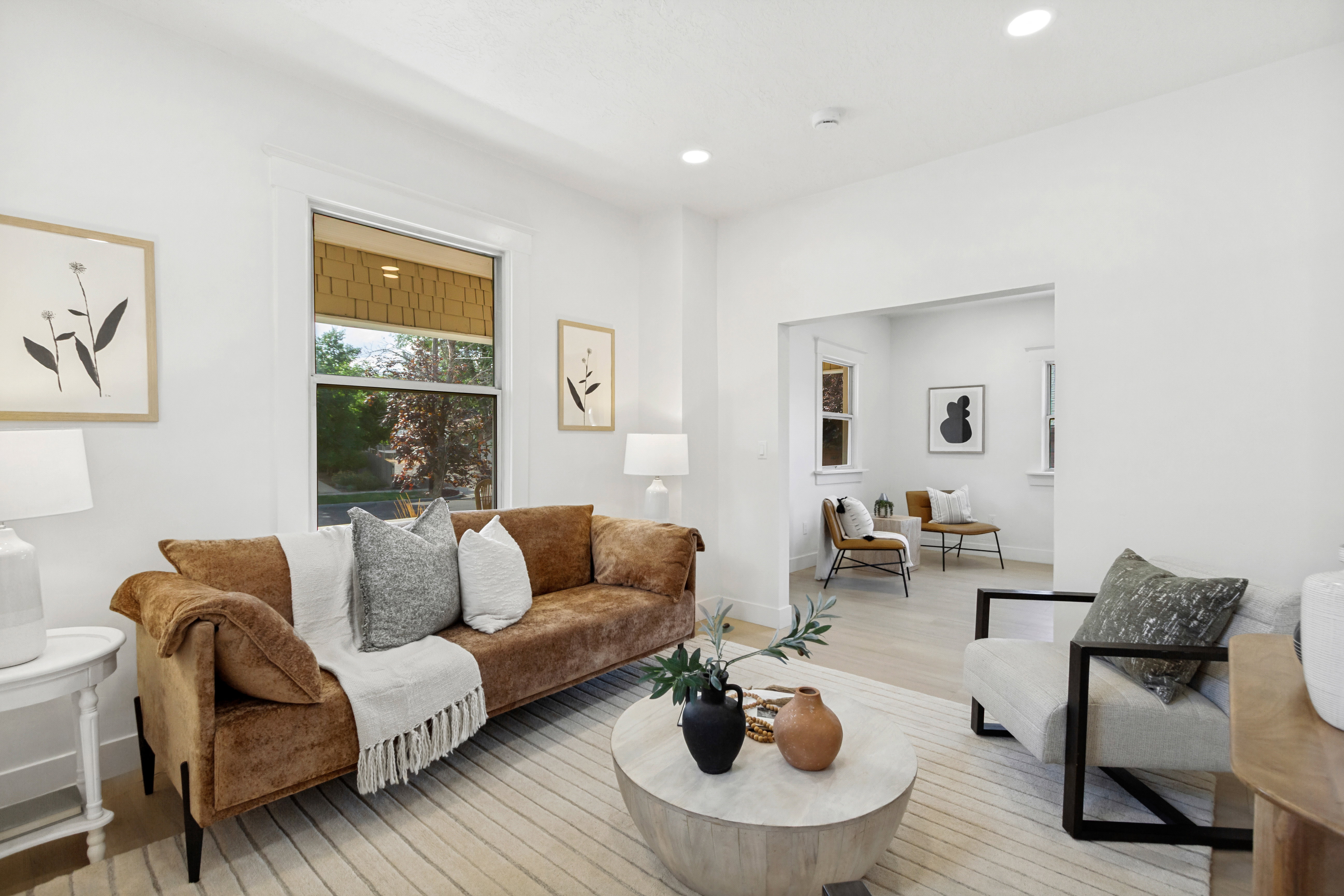 Bright living space featuring recessed lighting, light wood-finish flooring, and white trim