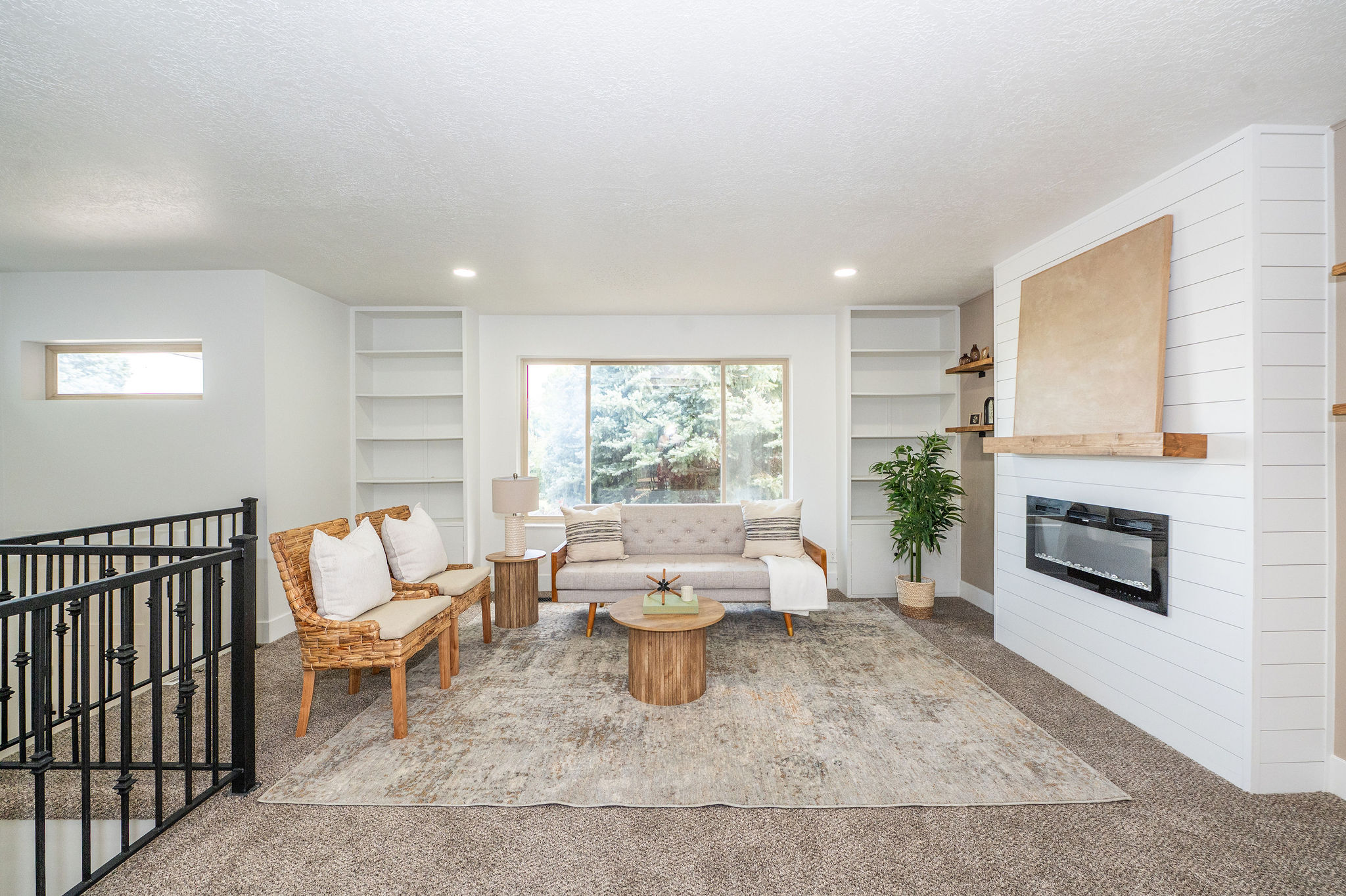 Living area featuring a shiplap-paneled fireplace with a linear insert and a wood mantel