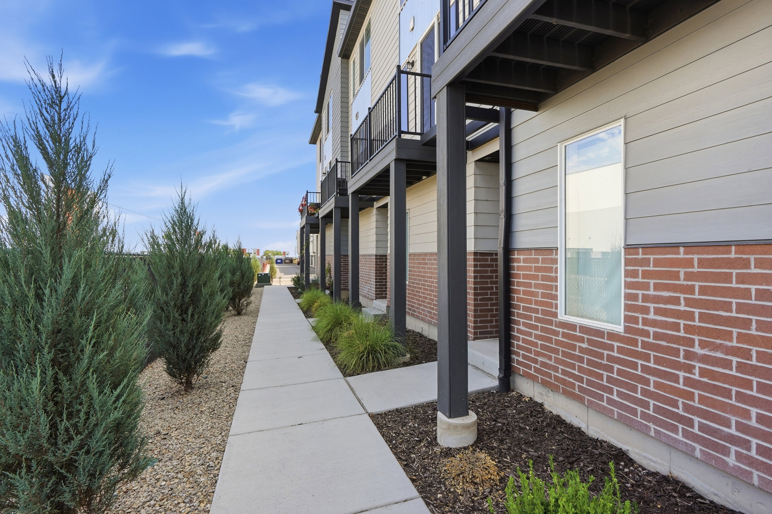 Contemporary multi-story exterior with brick and horizontal siding