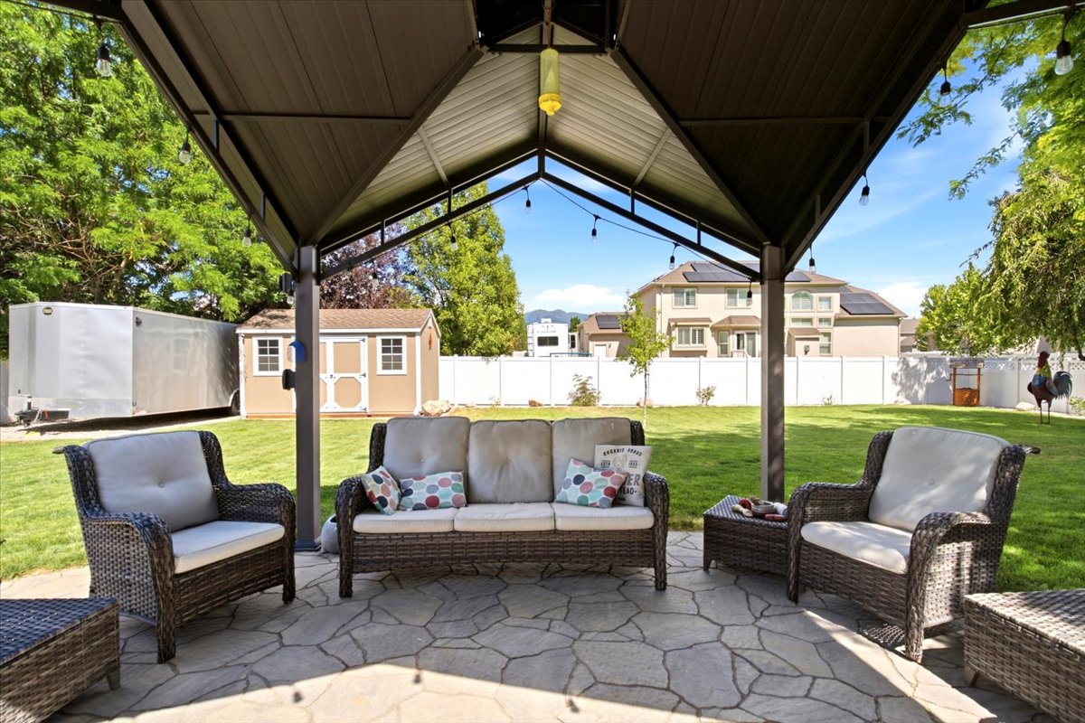 Flagstone patio with a metal gazebo featuring string lights